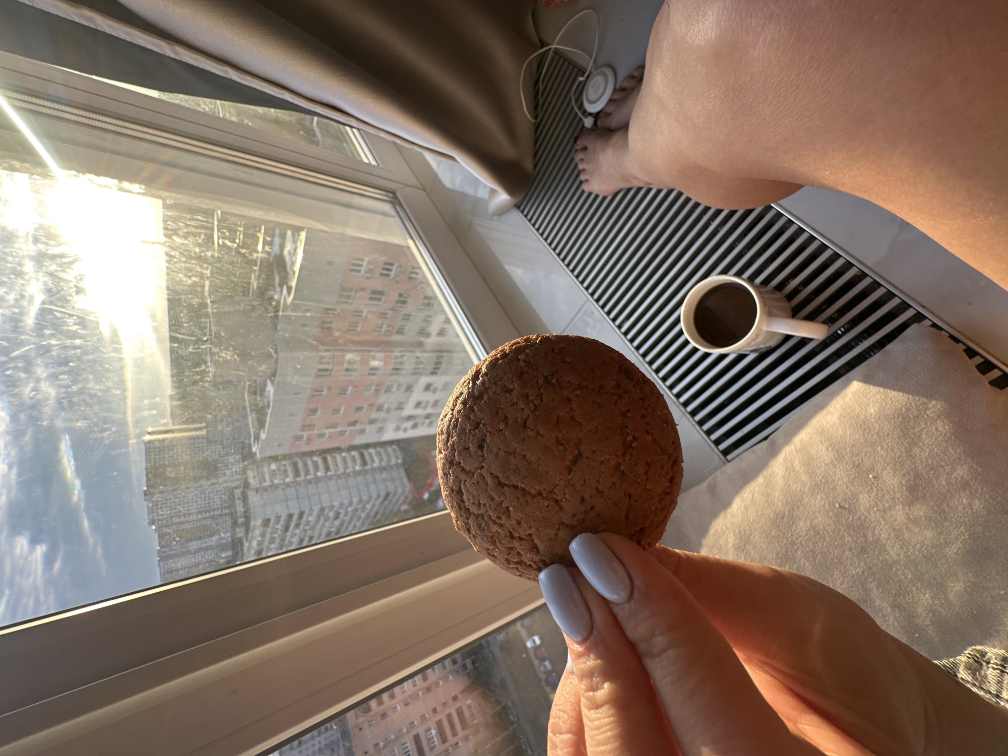 Person enjoys snack by sunny window in Gavrilkovo