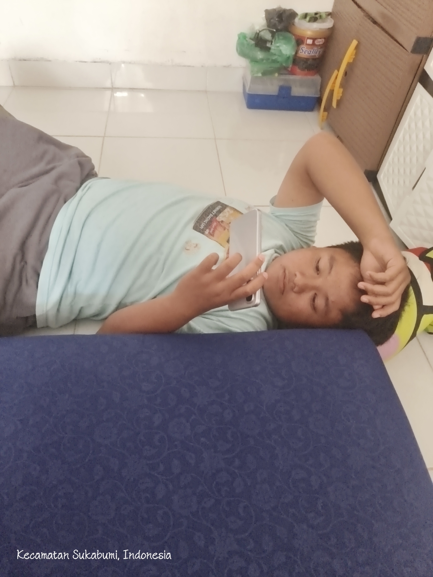 Everyday moments in Bandar Lampung — floors, phones, and tangled wires.