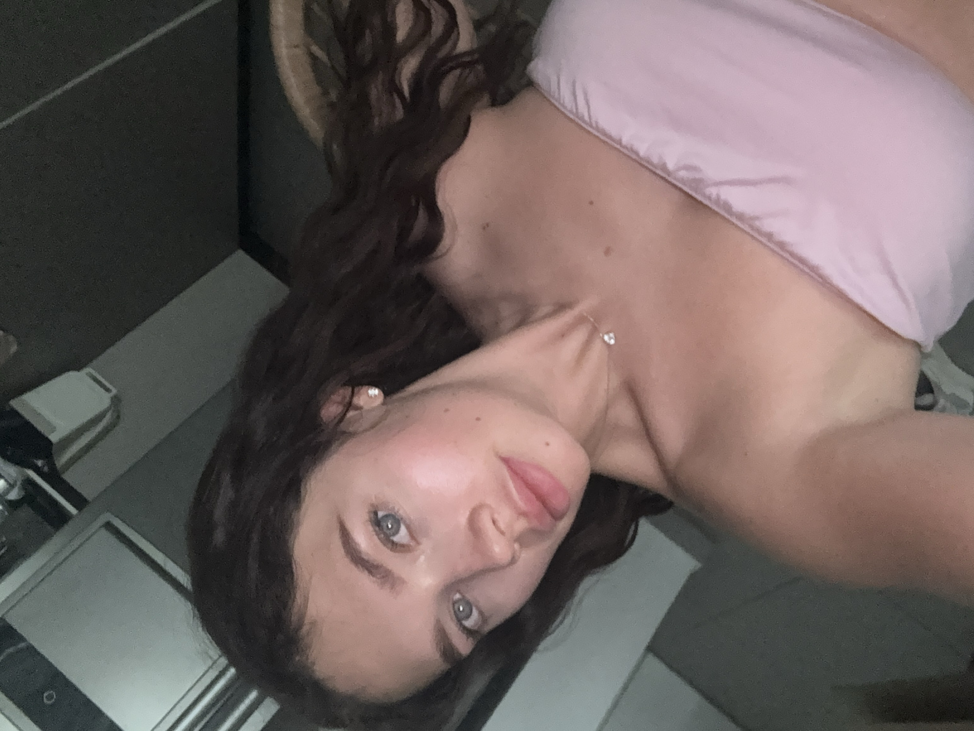Woman takes selfie in Givatayim wearing pink top