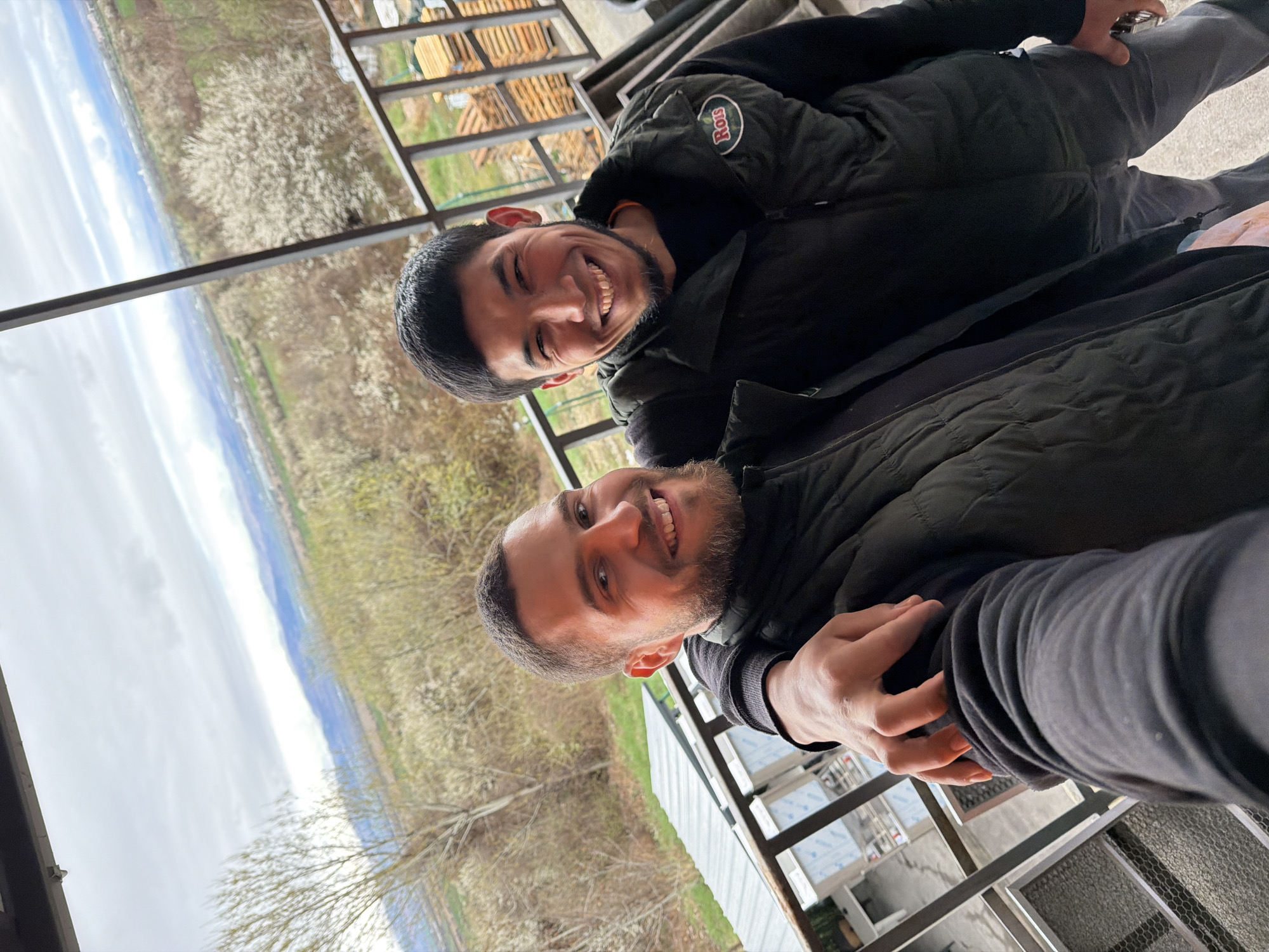 Two men take selfie on balcony in Lozen, Bulgaria