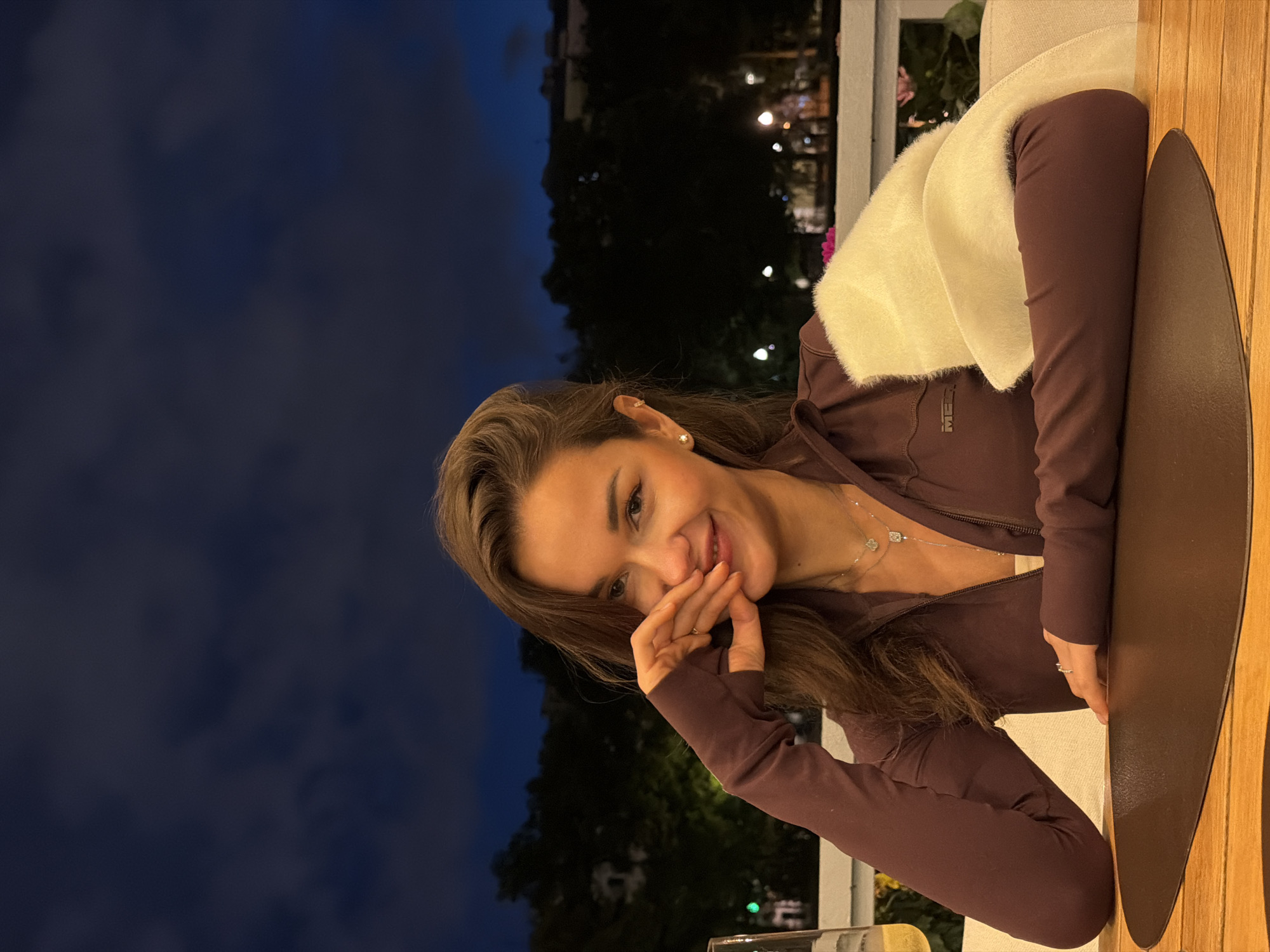 Evening table moment at a Moscow restaurant, white shawl, fingers raised
