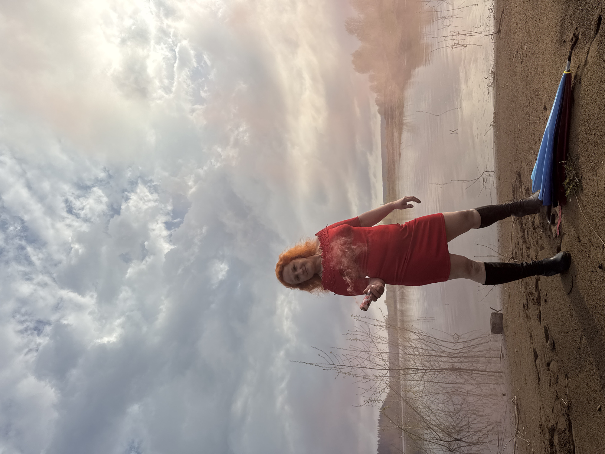 Woman conducts colorful smoke photo session near Russian lake