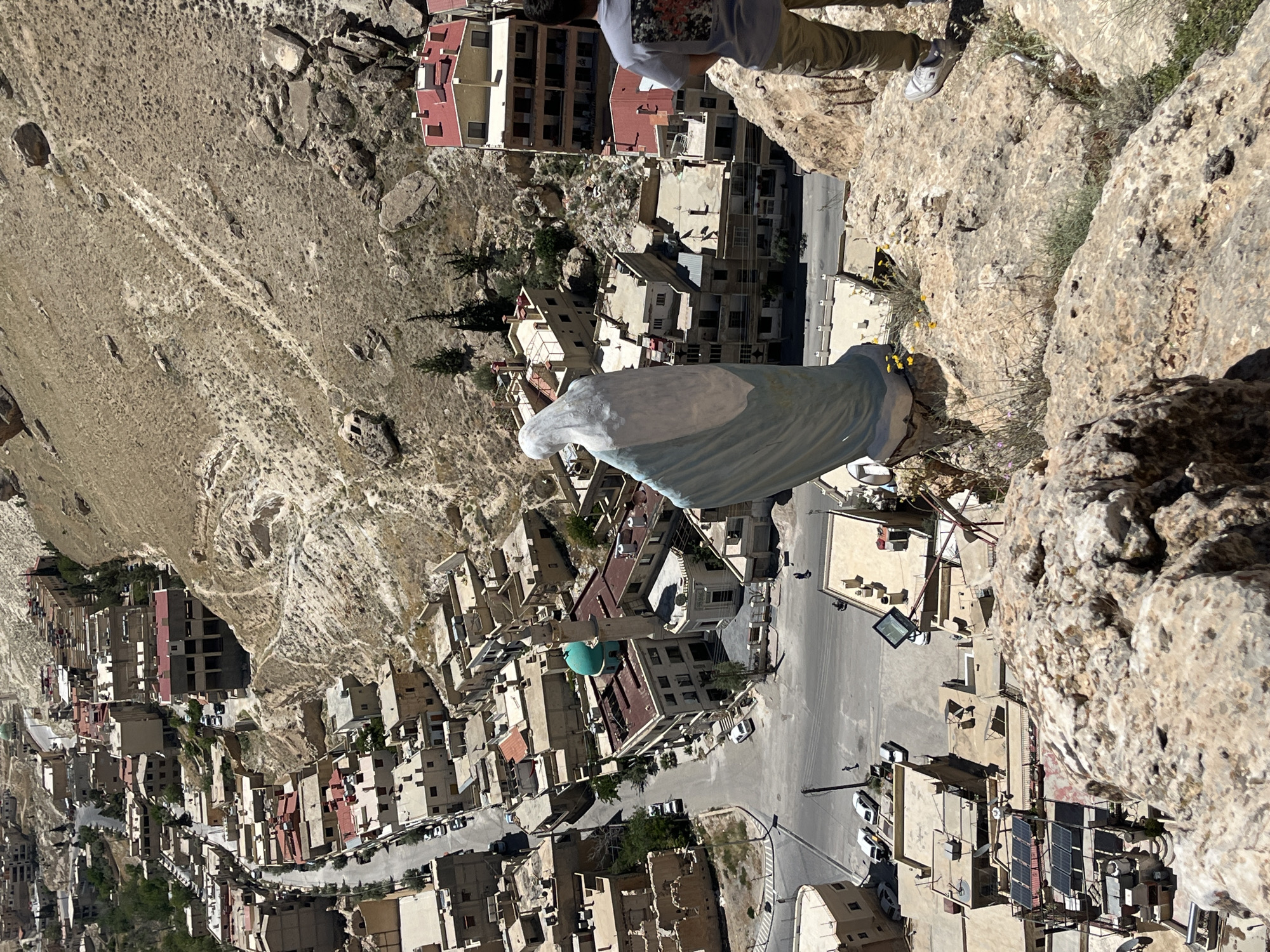 Tourists explore scenic overlooks above historic Ma'loula, Syria