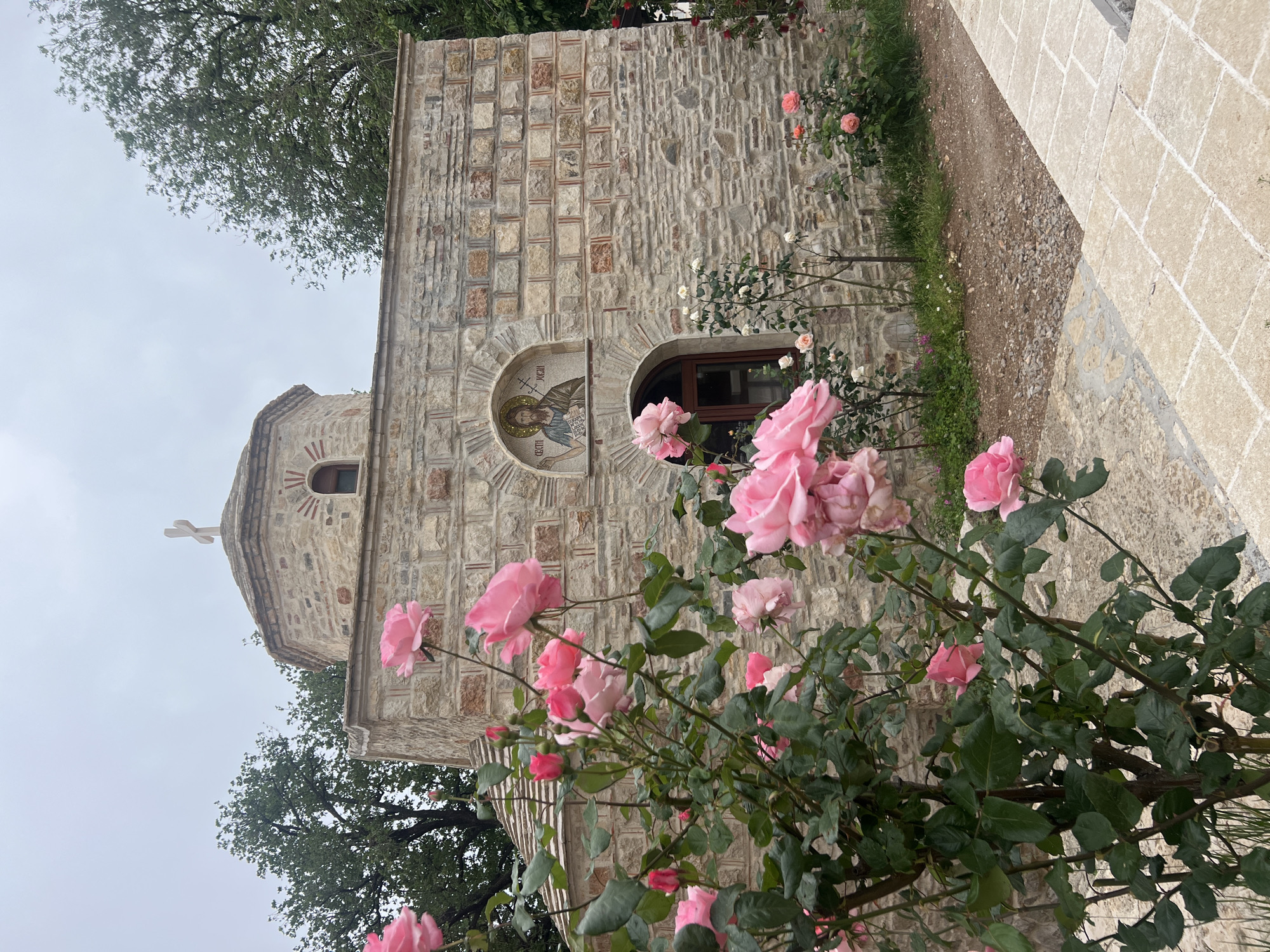 Stone church with rose garden documented in Budva, Montenegro