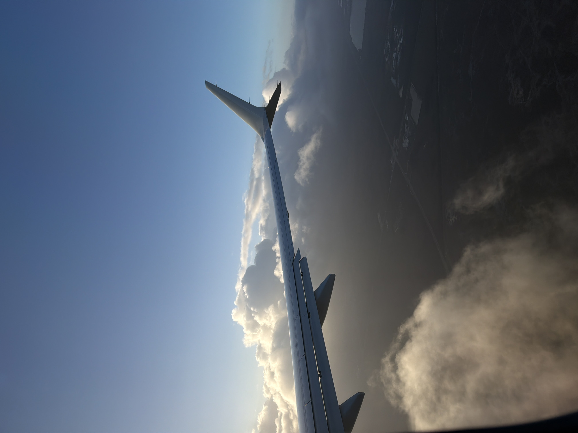 Passenger photographs airplane wing view over Tamiami