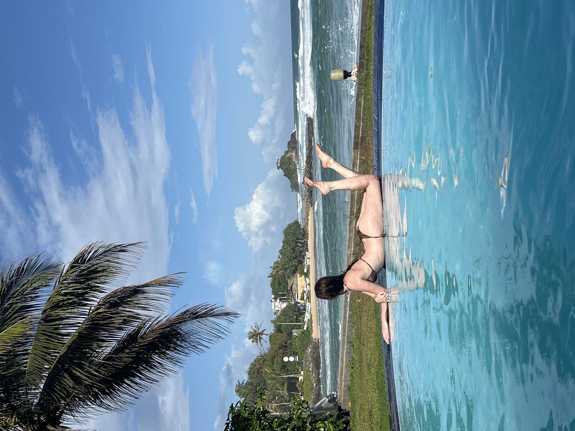 Women enjoy sunny poolside moments at Sri Lankan coastal resort