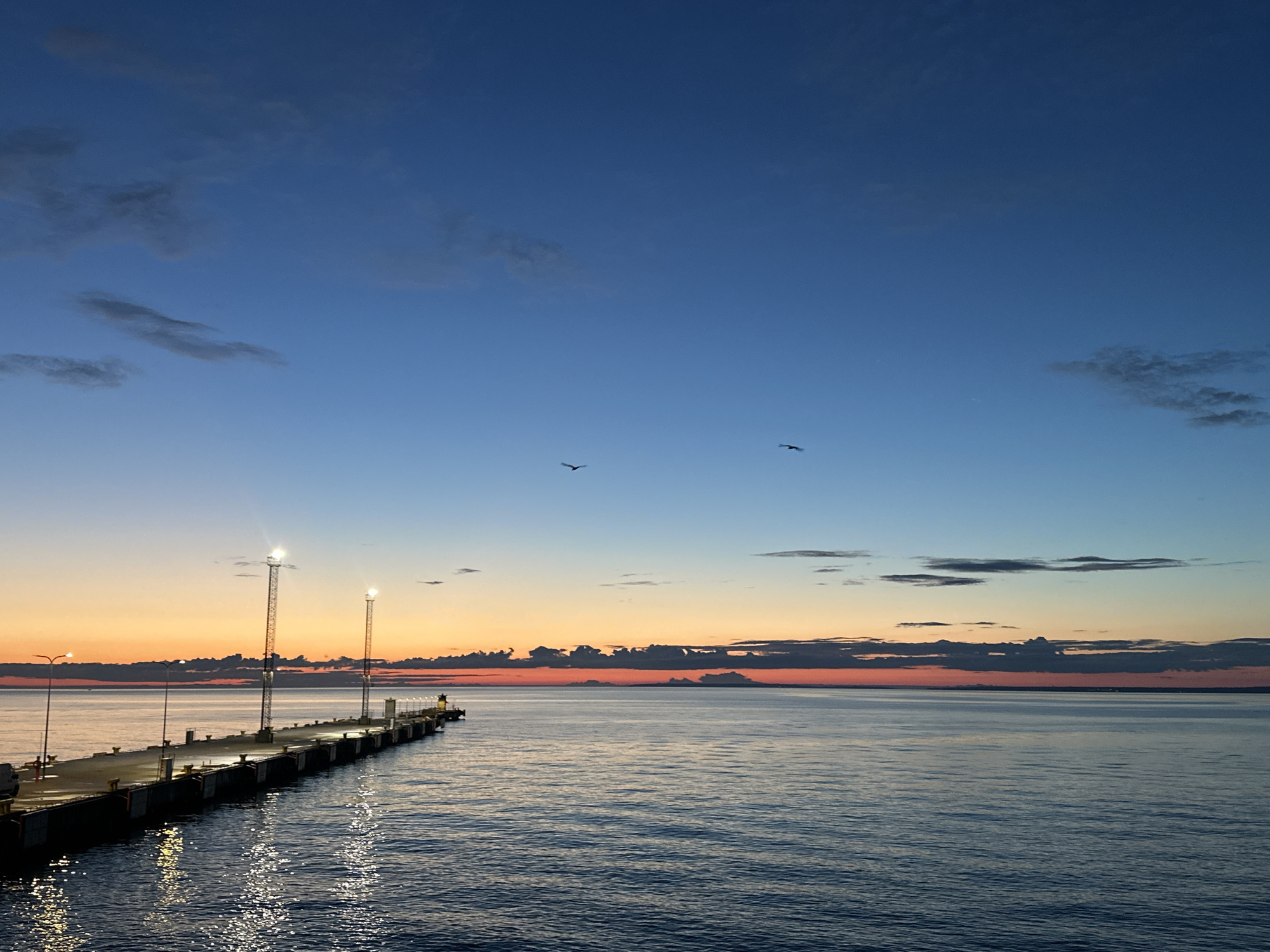 Tallinn harbor at dusk with ferries and scooter rides