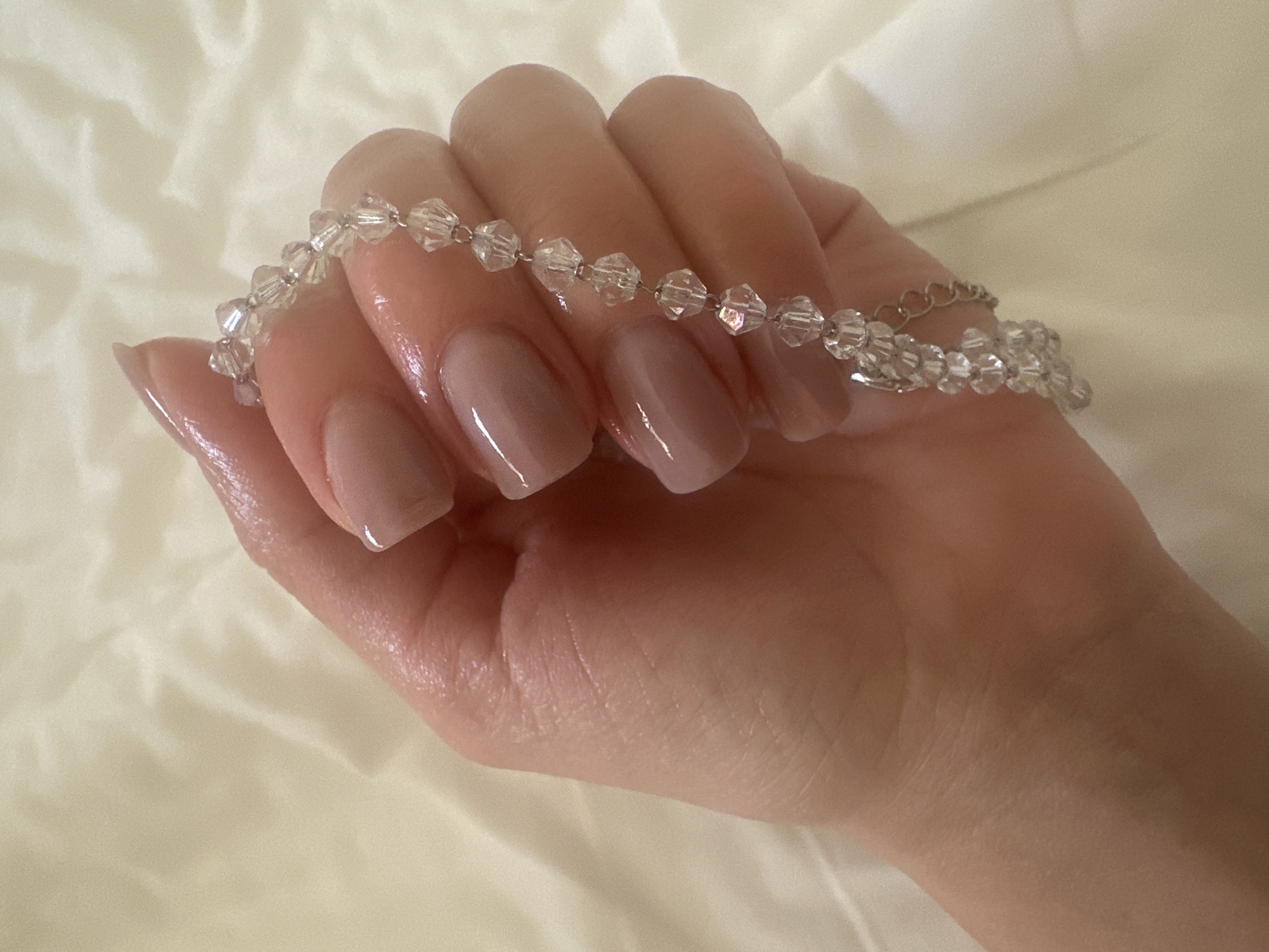 Person shows crystal beaded jewelry collection in Petah Tikva