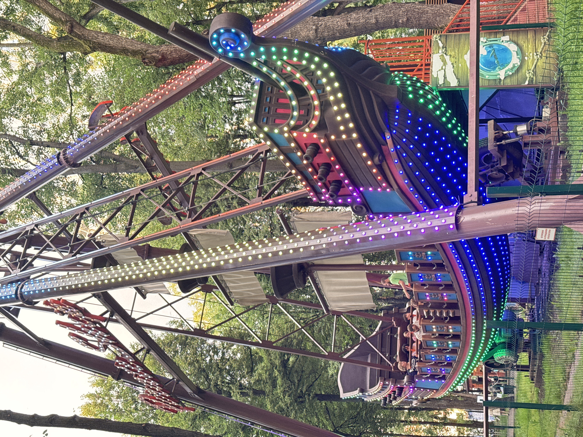 Amusement park rides lit up at dusk in Perm, Russia