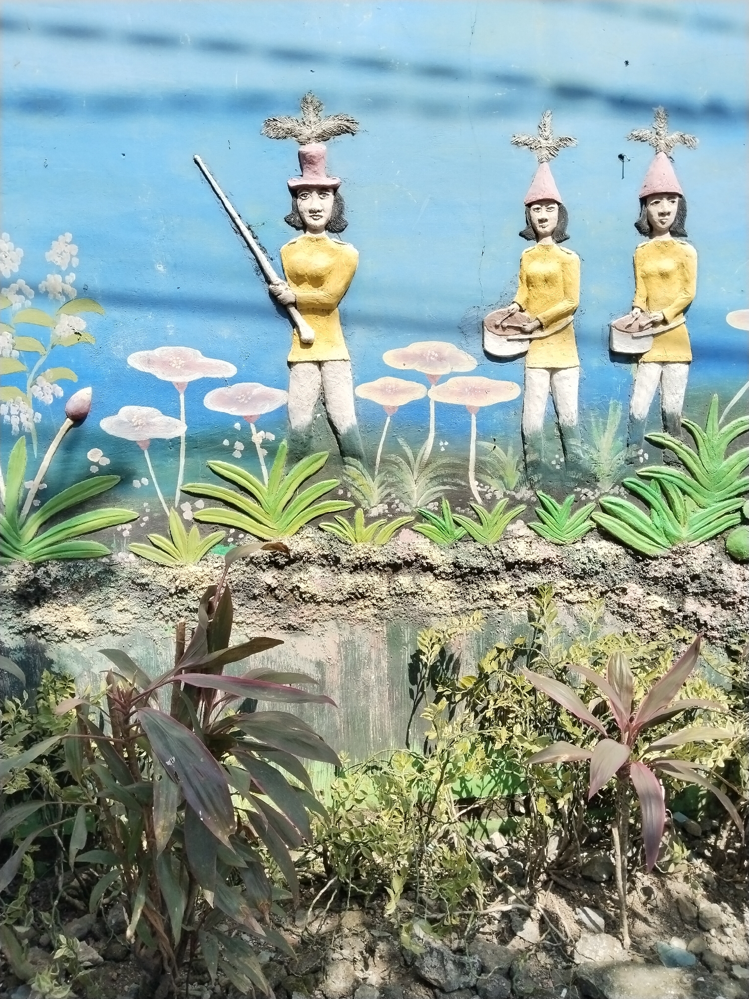 Relief sculpture with three figures spotted on Jirapan wall