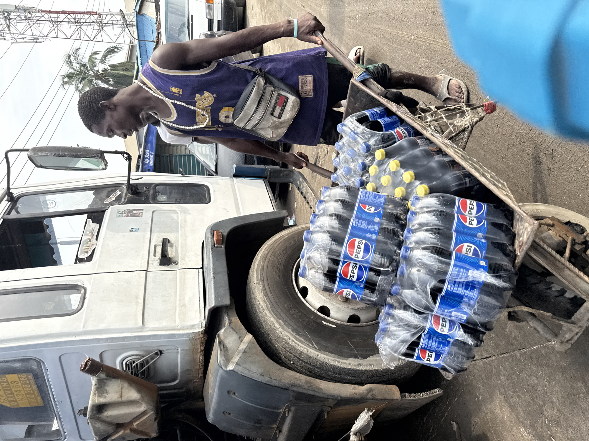 Man works with loaded handcart in Lekki, Lagos