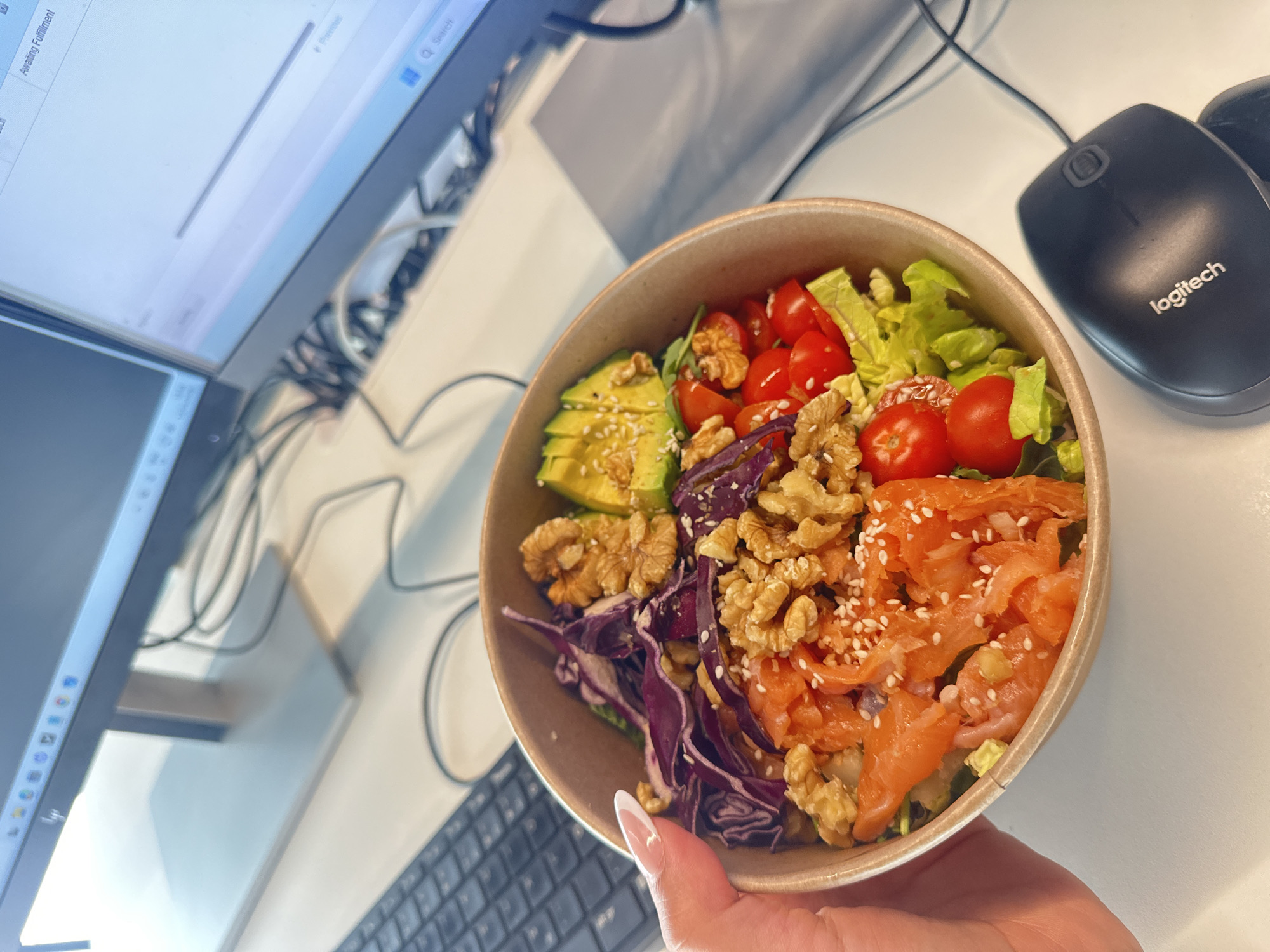 Person prepares salmon salad with dressing in Alicante