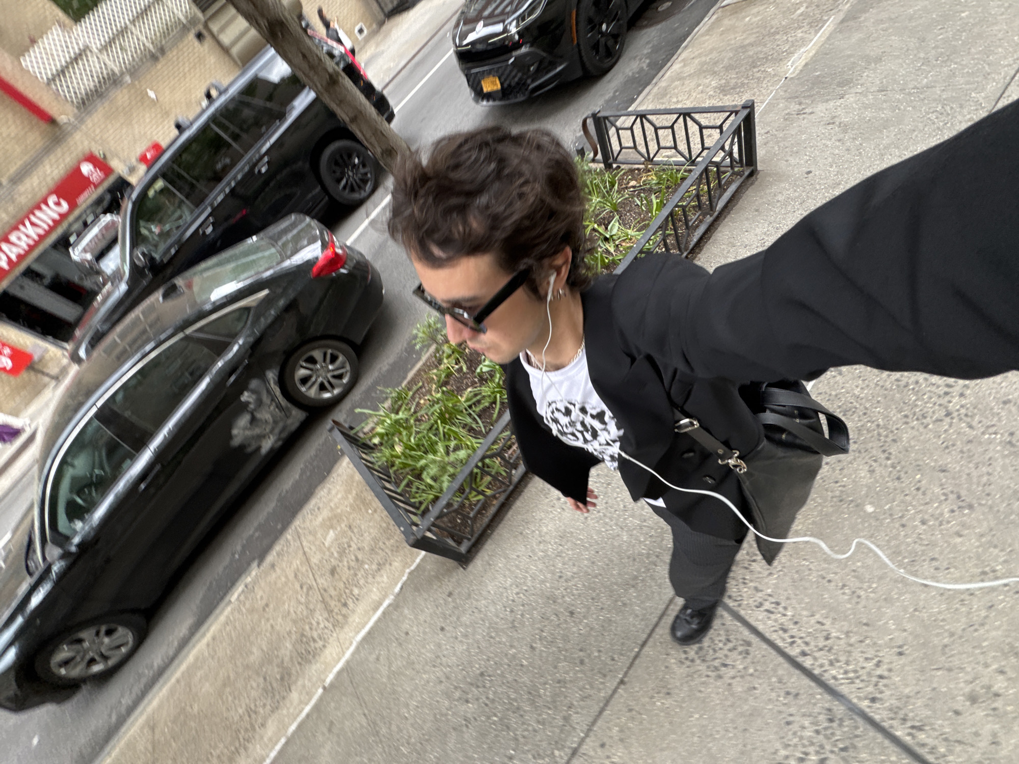 Person takes selfie on NYC sidewalk in business casual attire