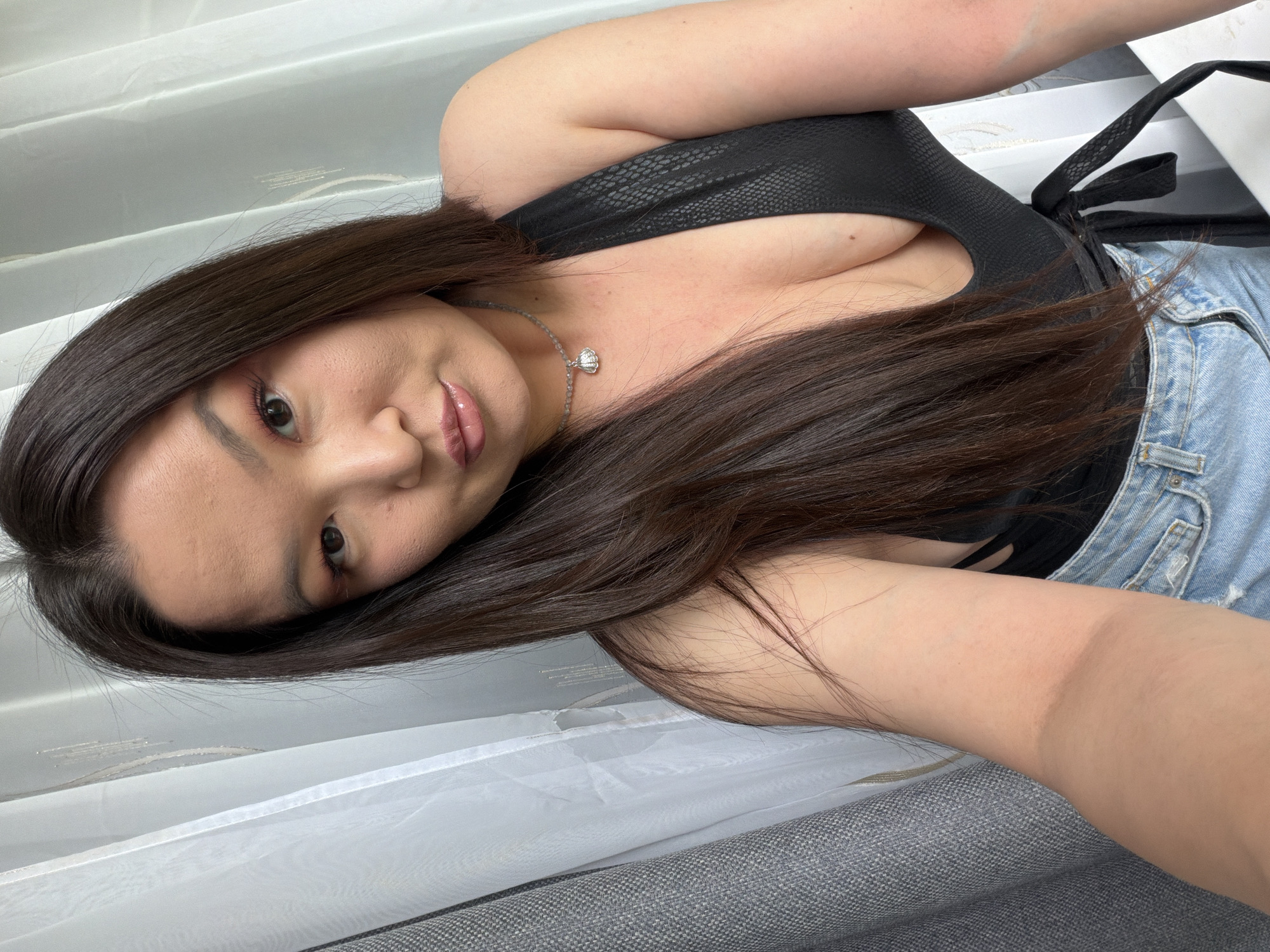 Woman takes selfie in black textured top