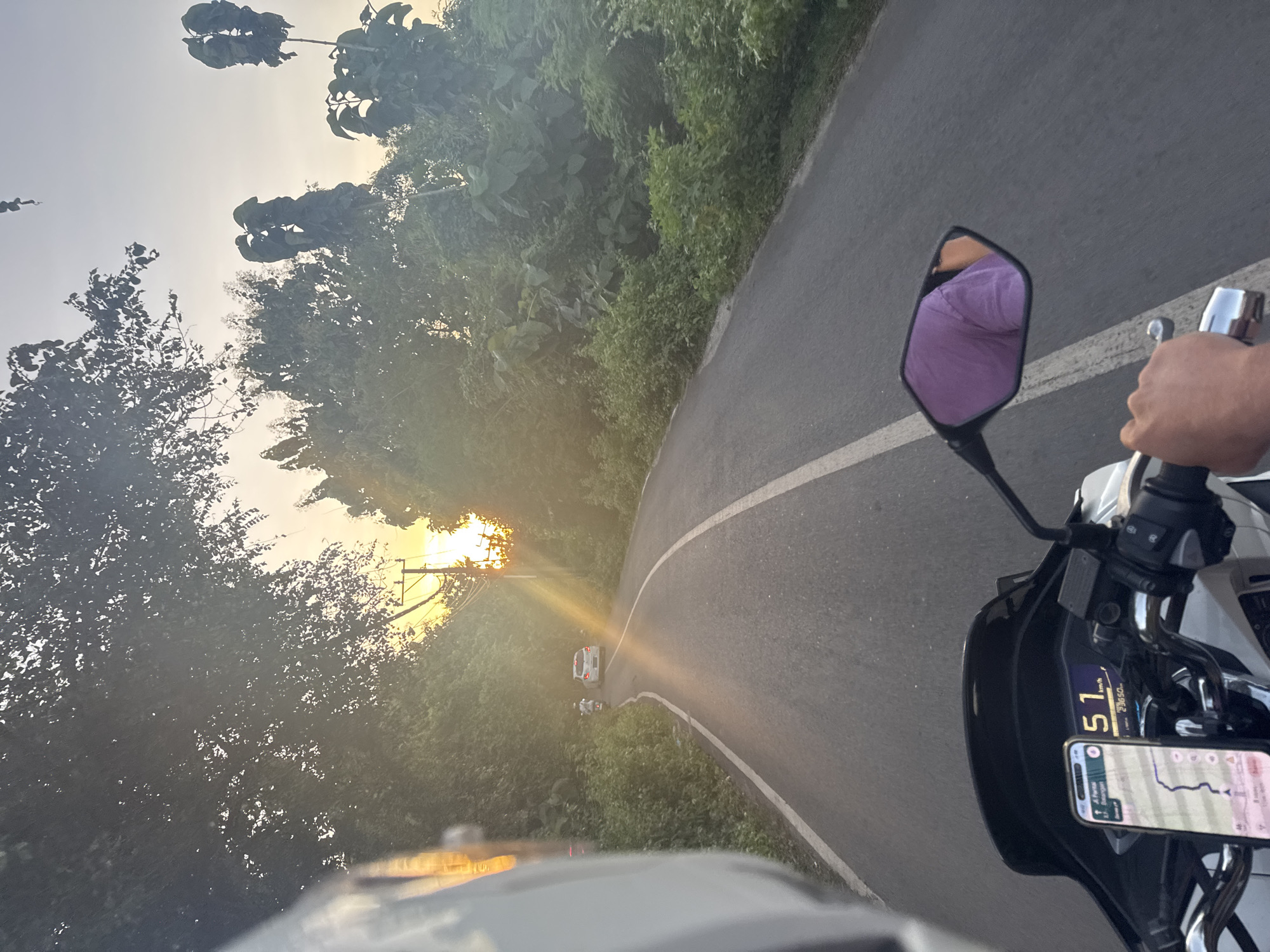 Motorcycle rider captures sunrise journey through scenic roads