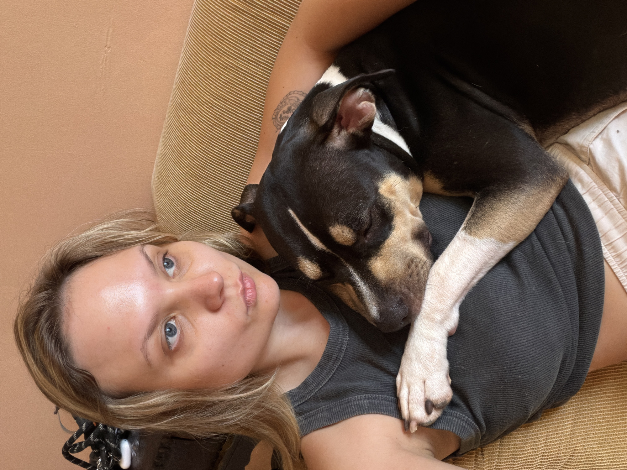 Woman and dog share quiet moment on Tel Aviv couch