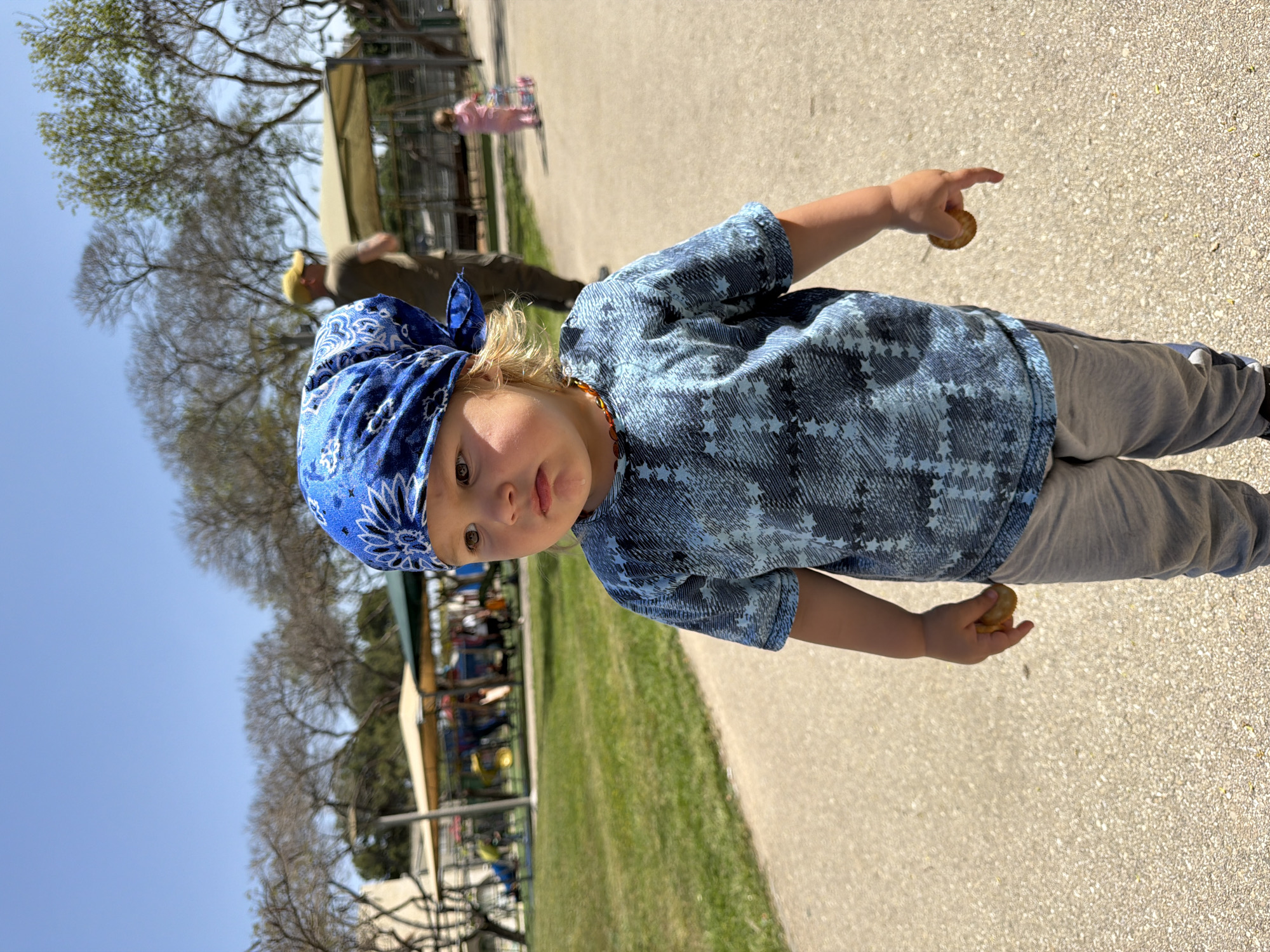 Child in blue bandana spotted on park path in Kiryat Bialik