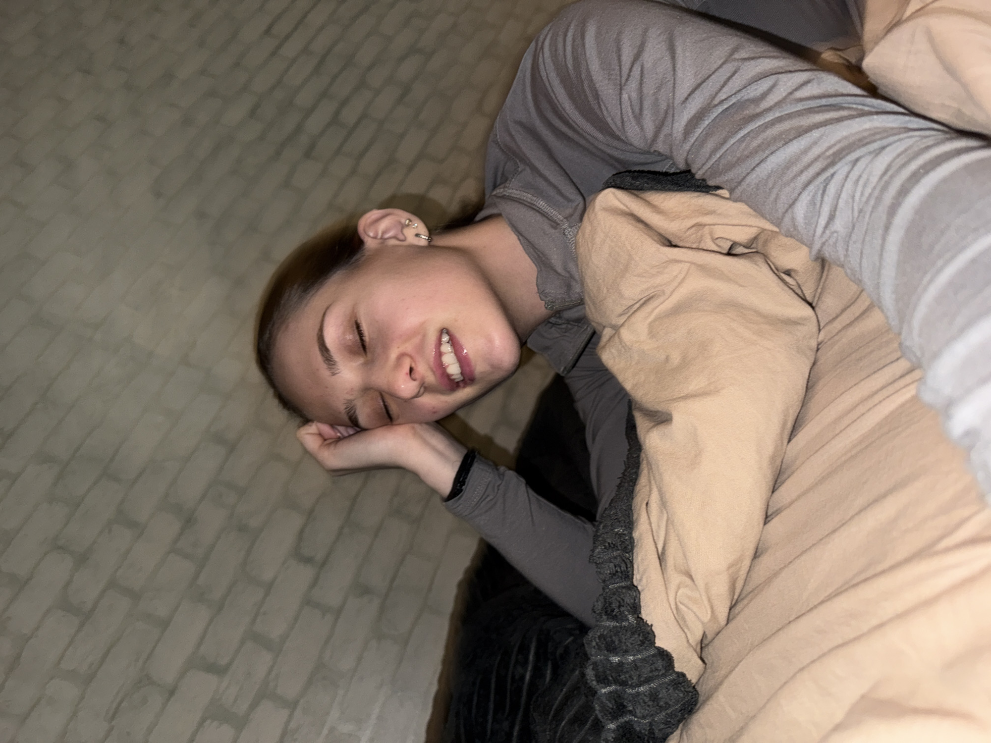 Woman rests on bed in Sofia apartment