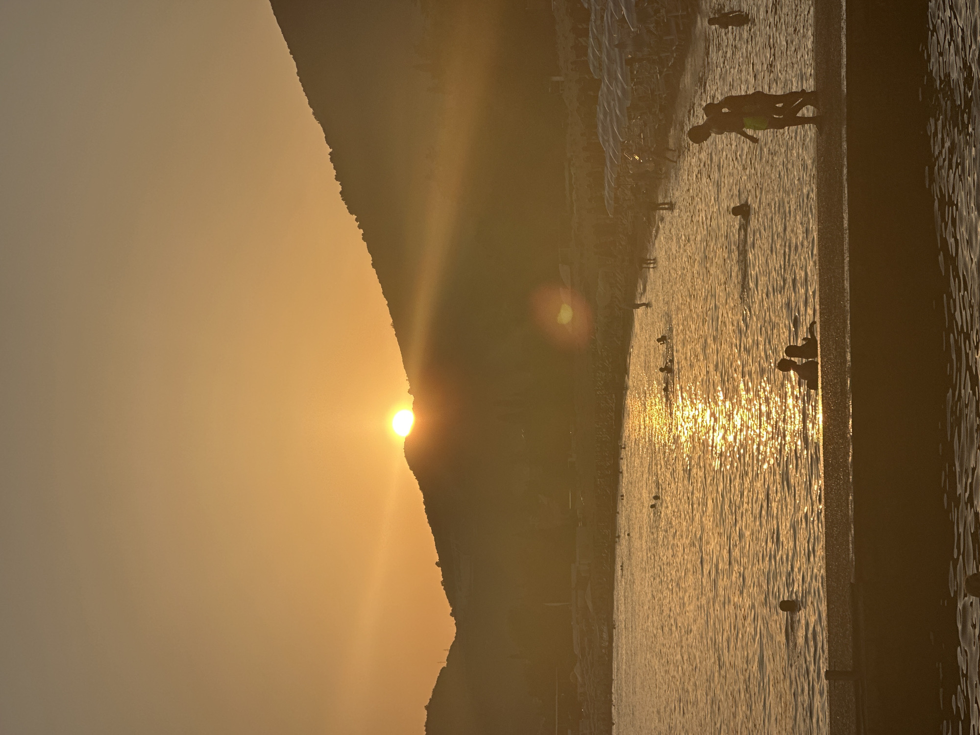 Sunset hour on the Budva waterfront: boats, parasails, and a sleeping cat