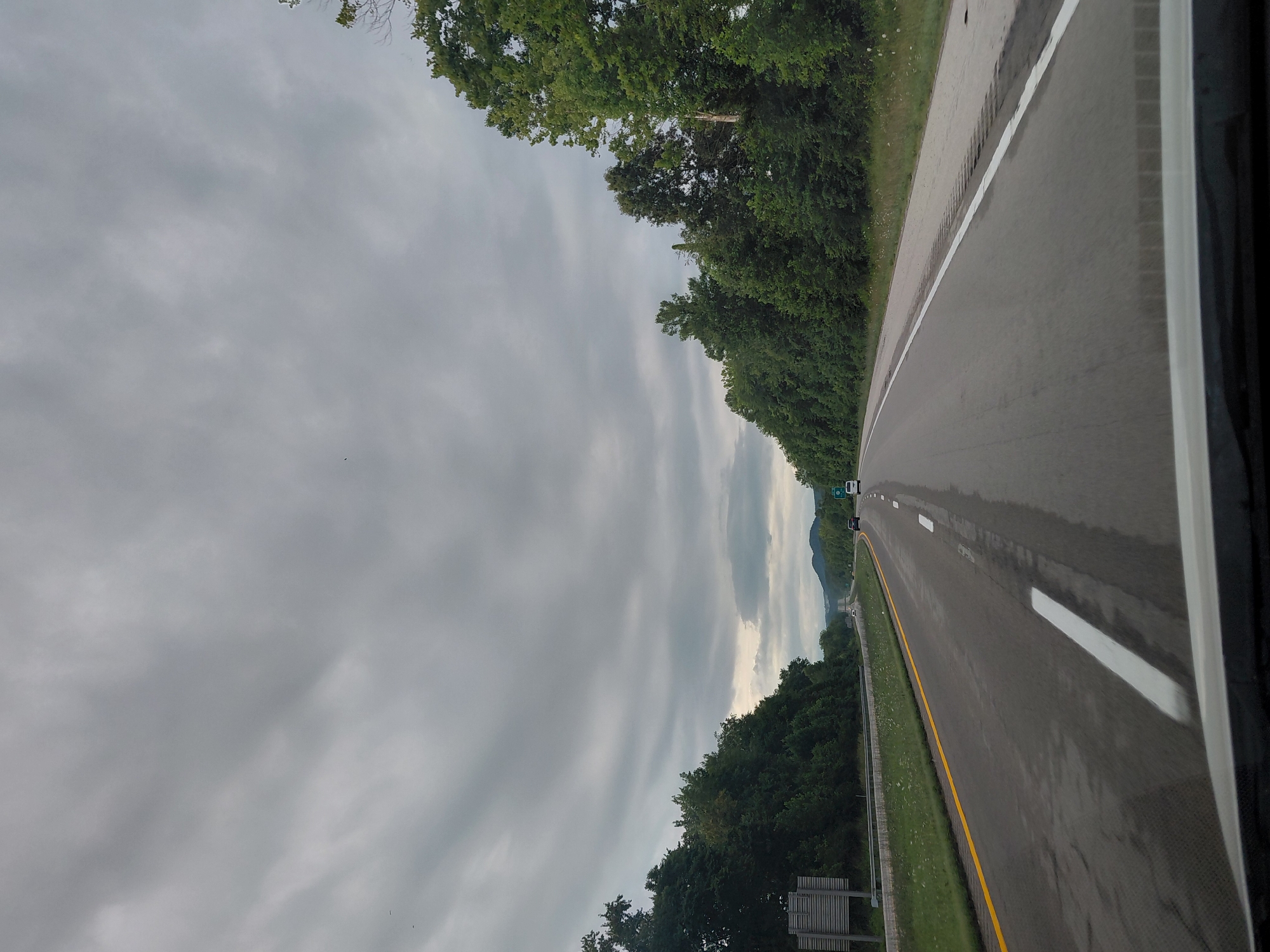 Driving through a tree-lined two-lane highway in Clay City