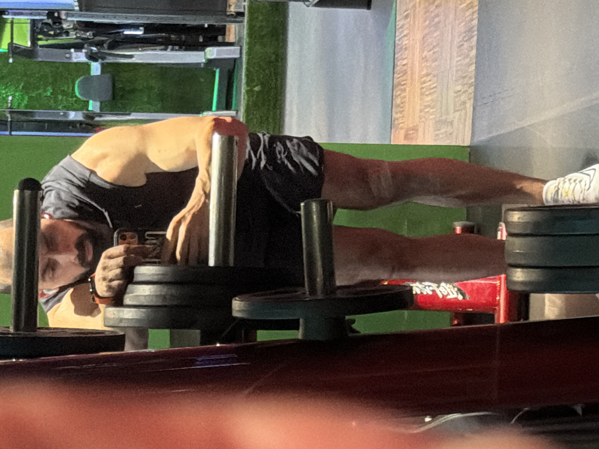 Man prepares barbell with weights at Plovdiv gym