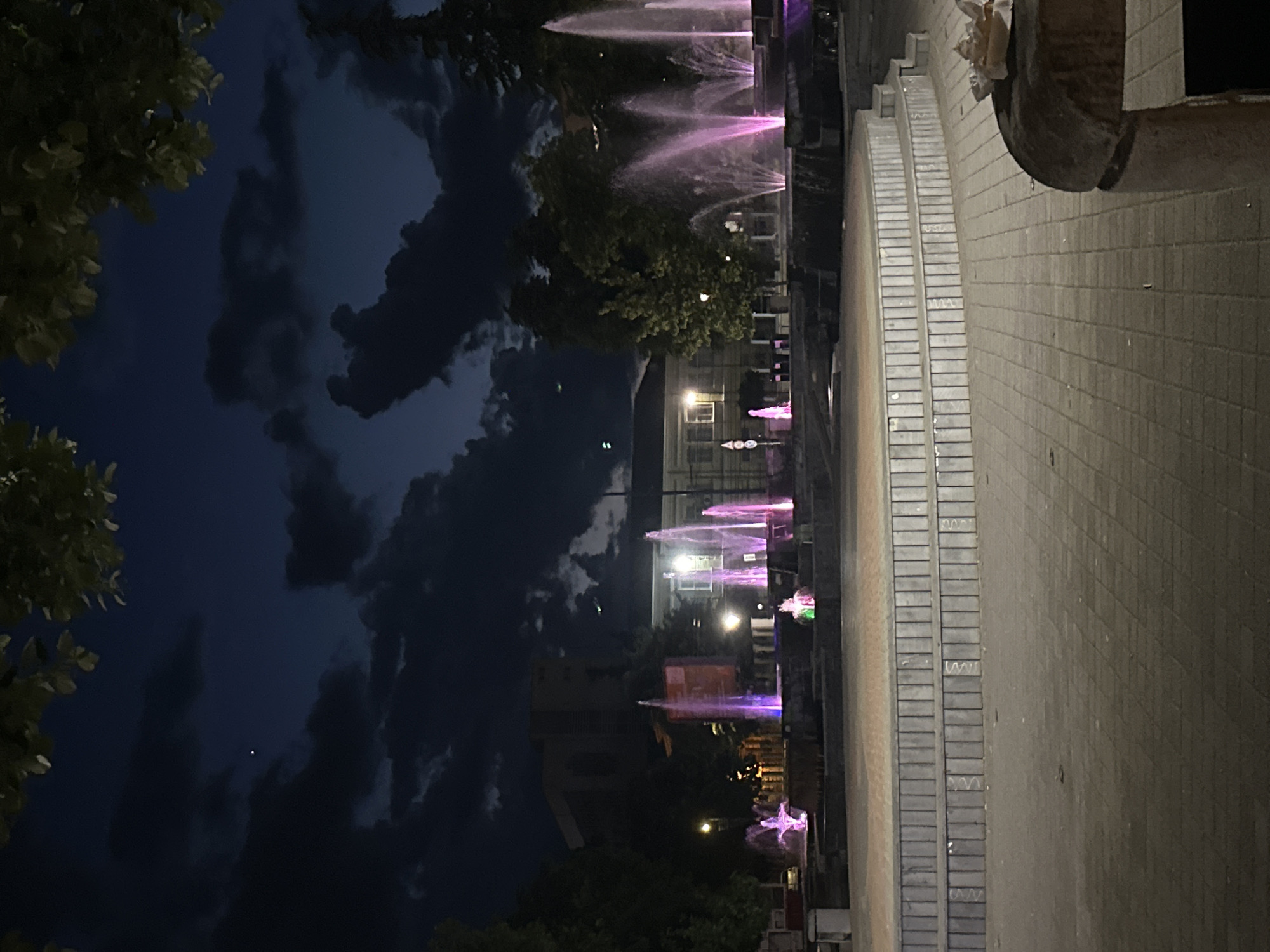 Evening scenes captured in Pazardzhik: lit fountains, young men outdoors