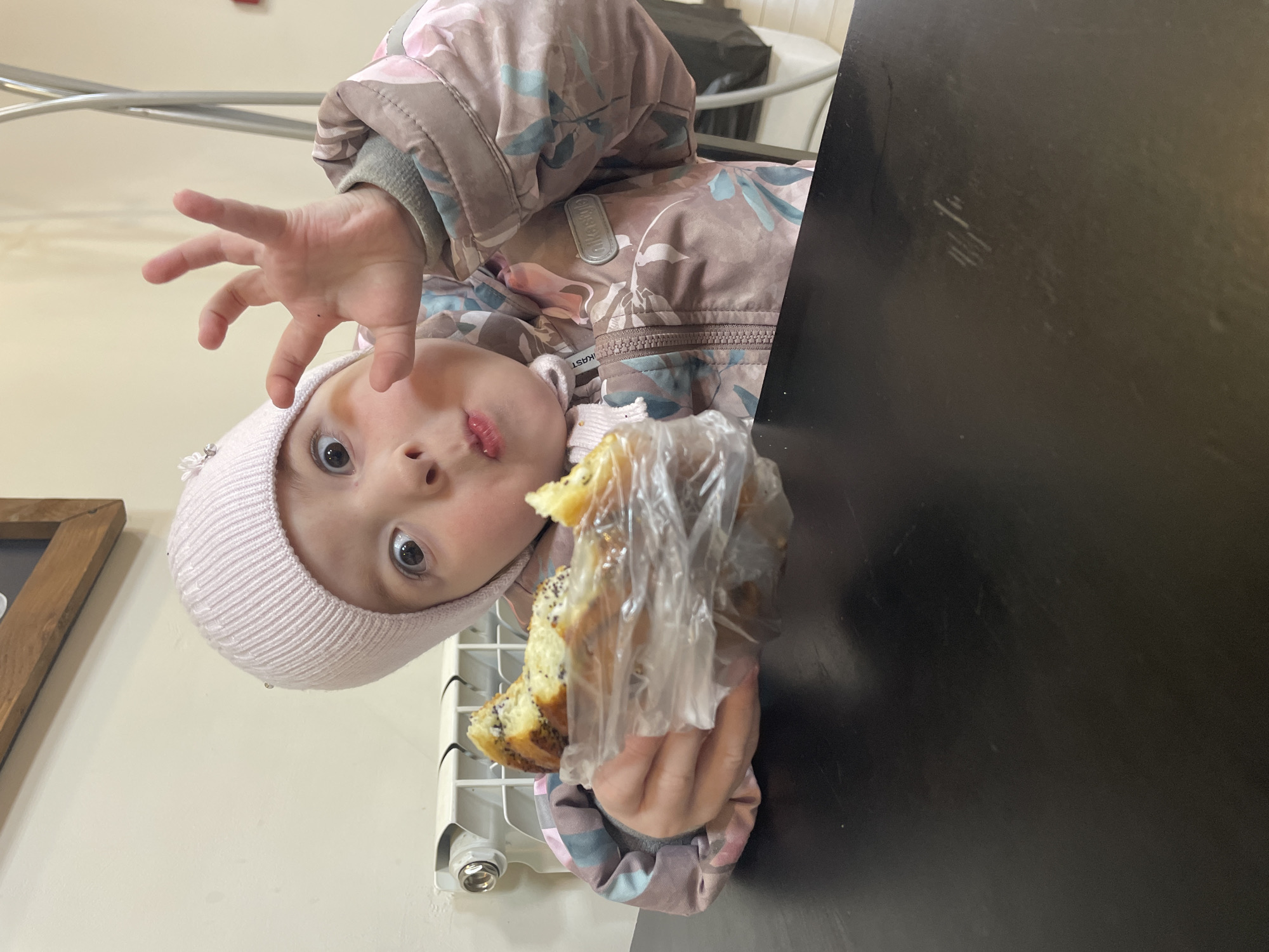 Child with pastry spotted in winter clothing in Chaikovsky