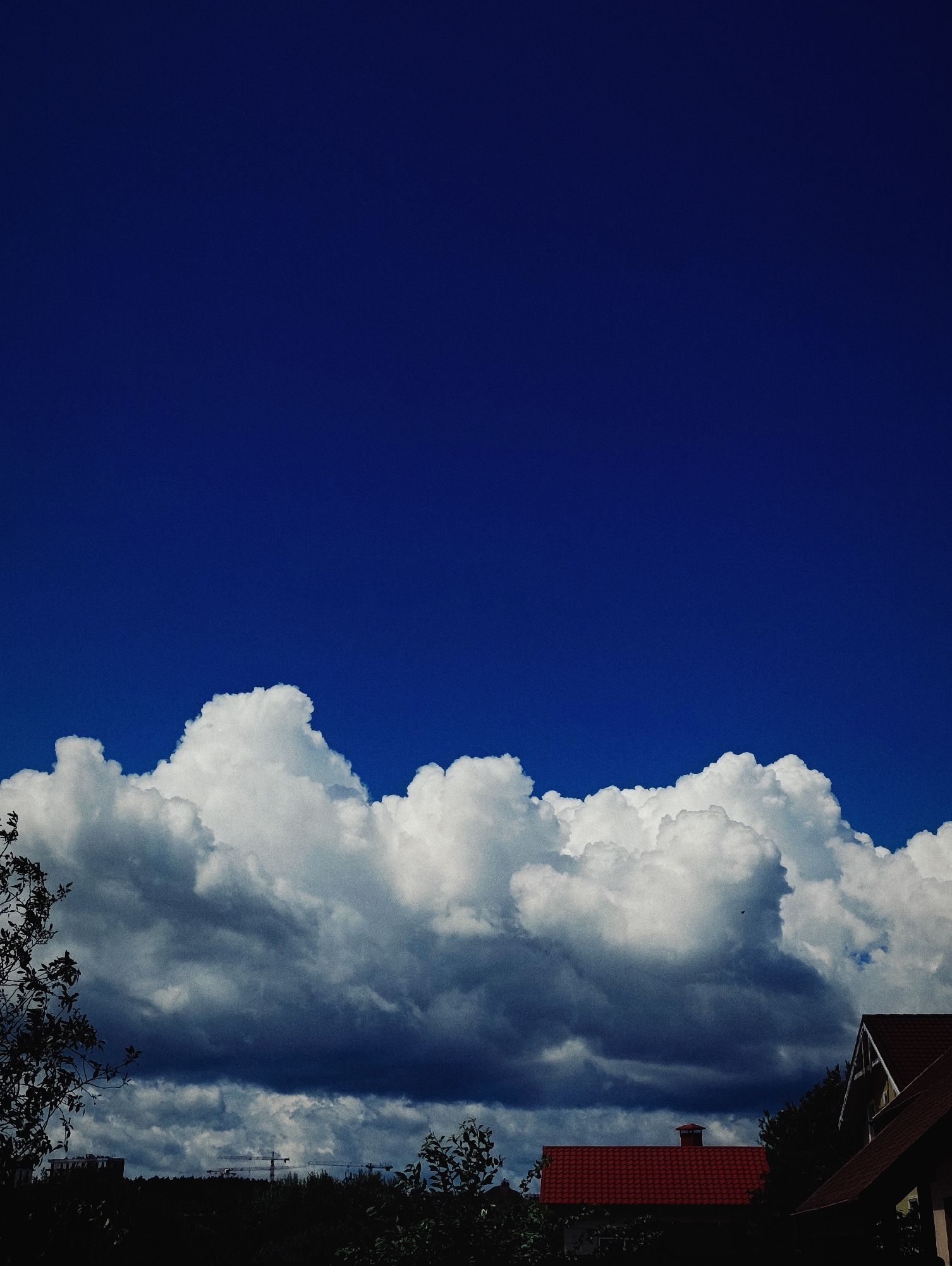 Dramatic skies and storm clouds rolling over a suburban landscape