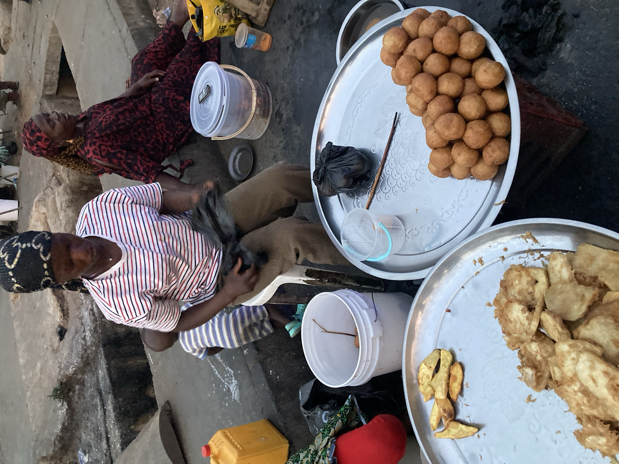 Women sell traditional street food in Jos, Nigeria