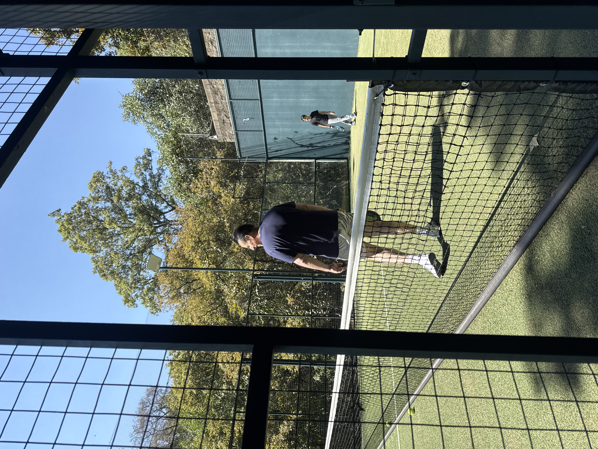 Man plays paddle tennis on outdoor court in Mexico City