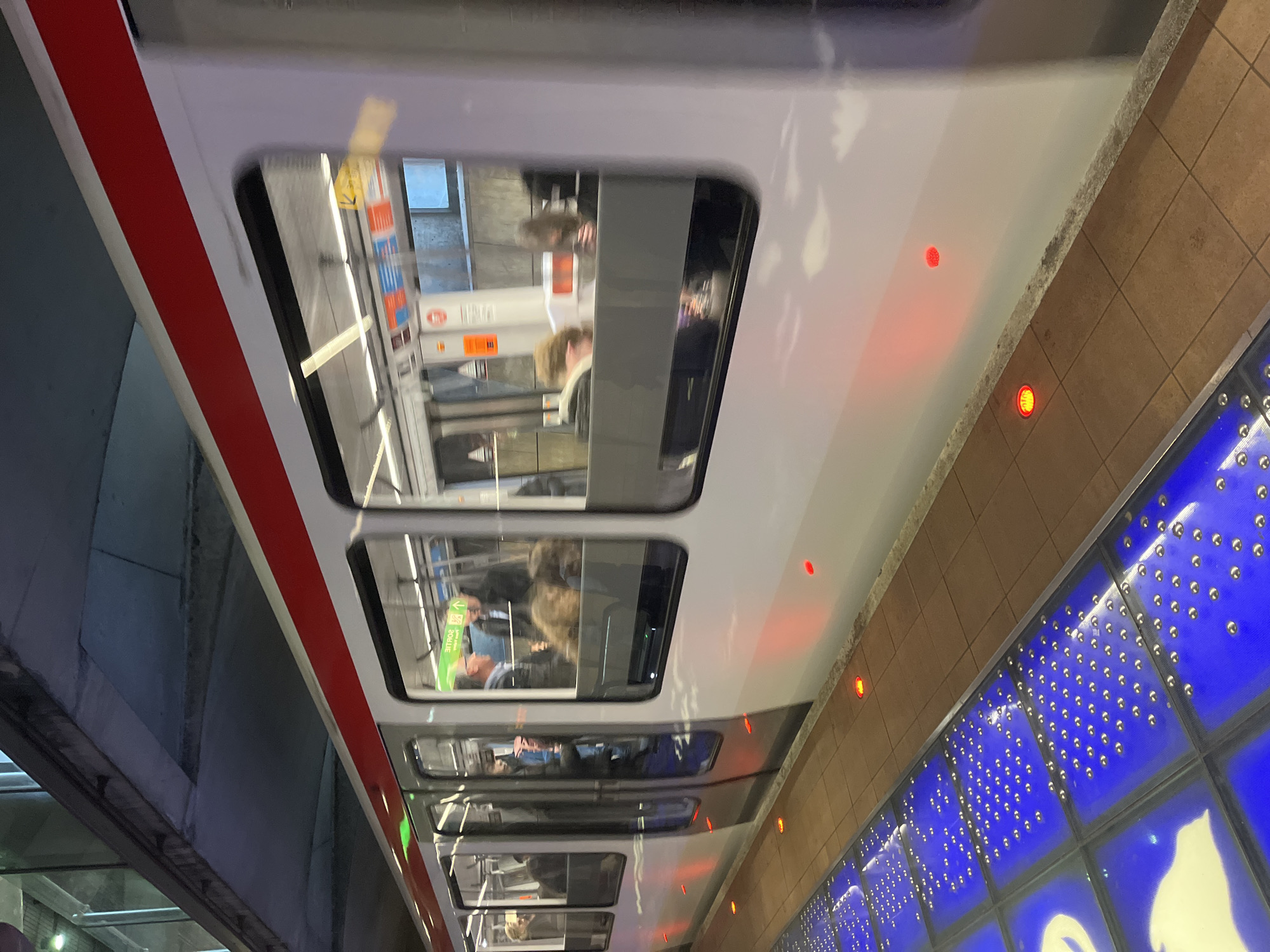 Lyon Metro train observed at station with passengers visible