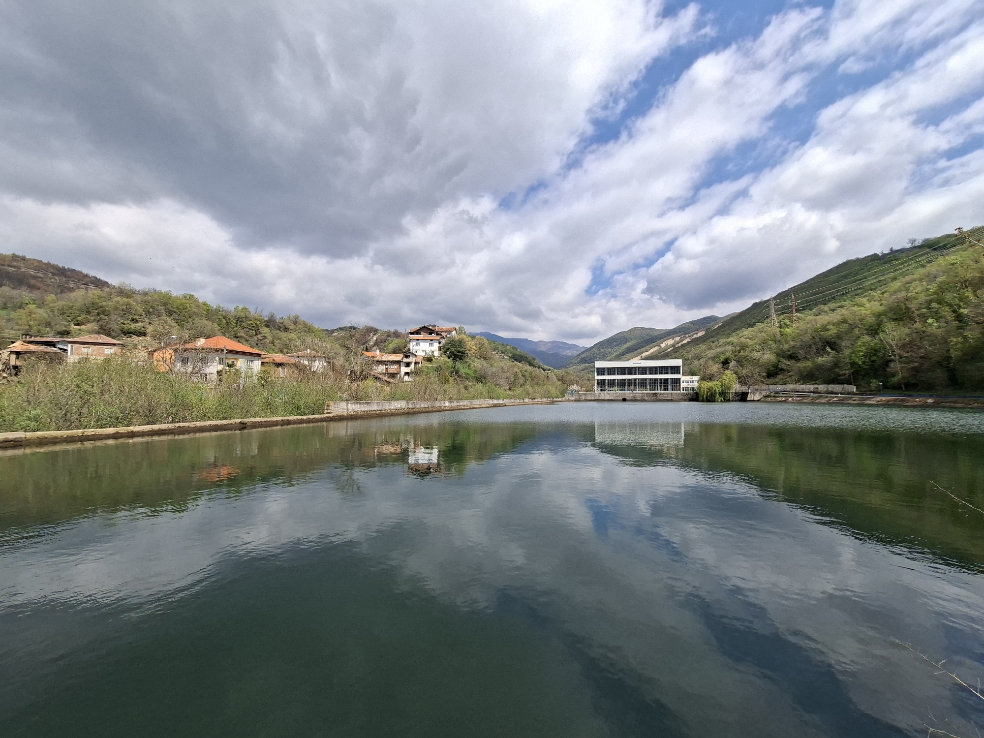 Witness documents calm urban waterway with modern building reflections