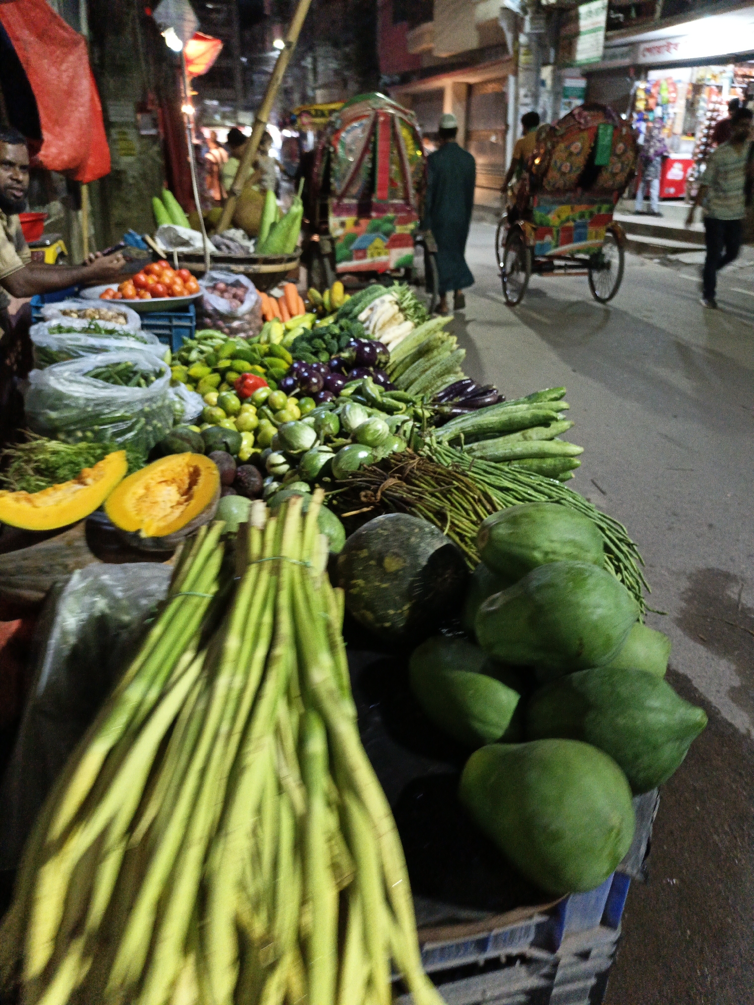 Nighttime street life in Dhaka — markets, wires, and traffic