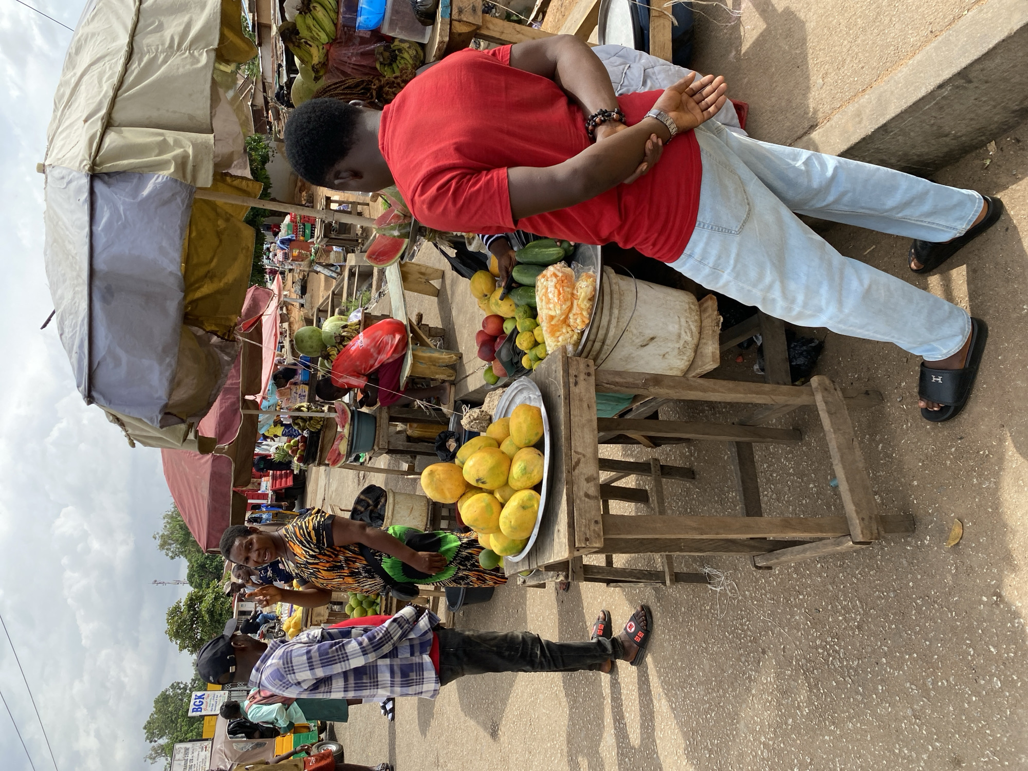 Outdoor market vendors sell produce in Bukuru, Nigeria