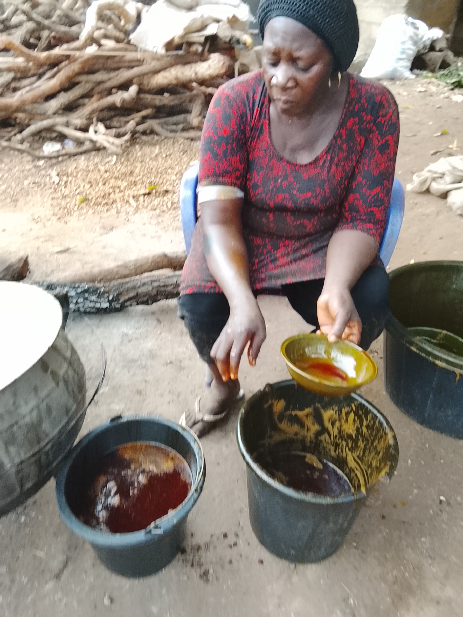 Woman processes plant material outdoors in extended afternoon session