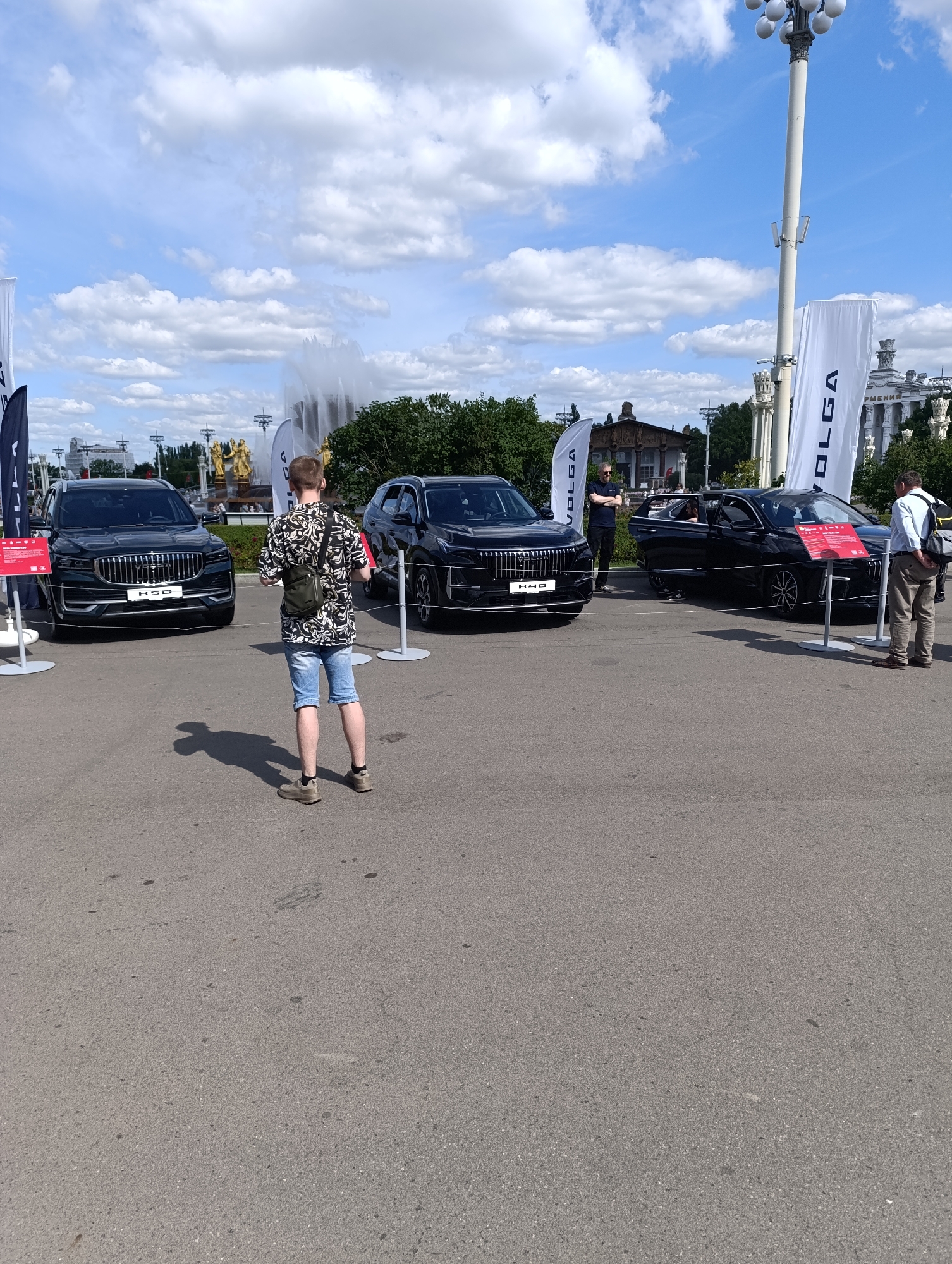 Car show and fountain scenes at Moscow's VDNKh on a summer morning