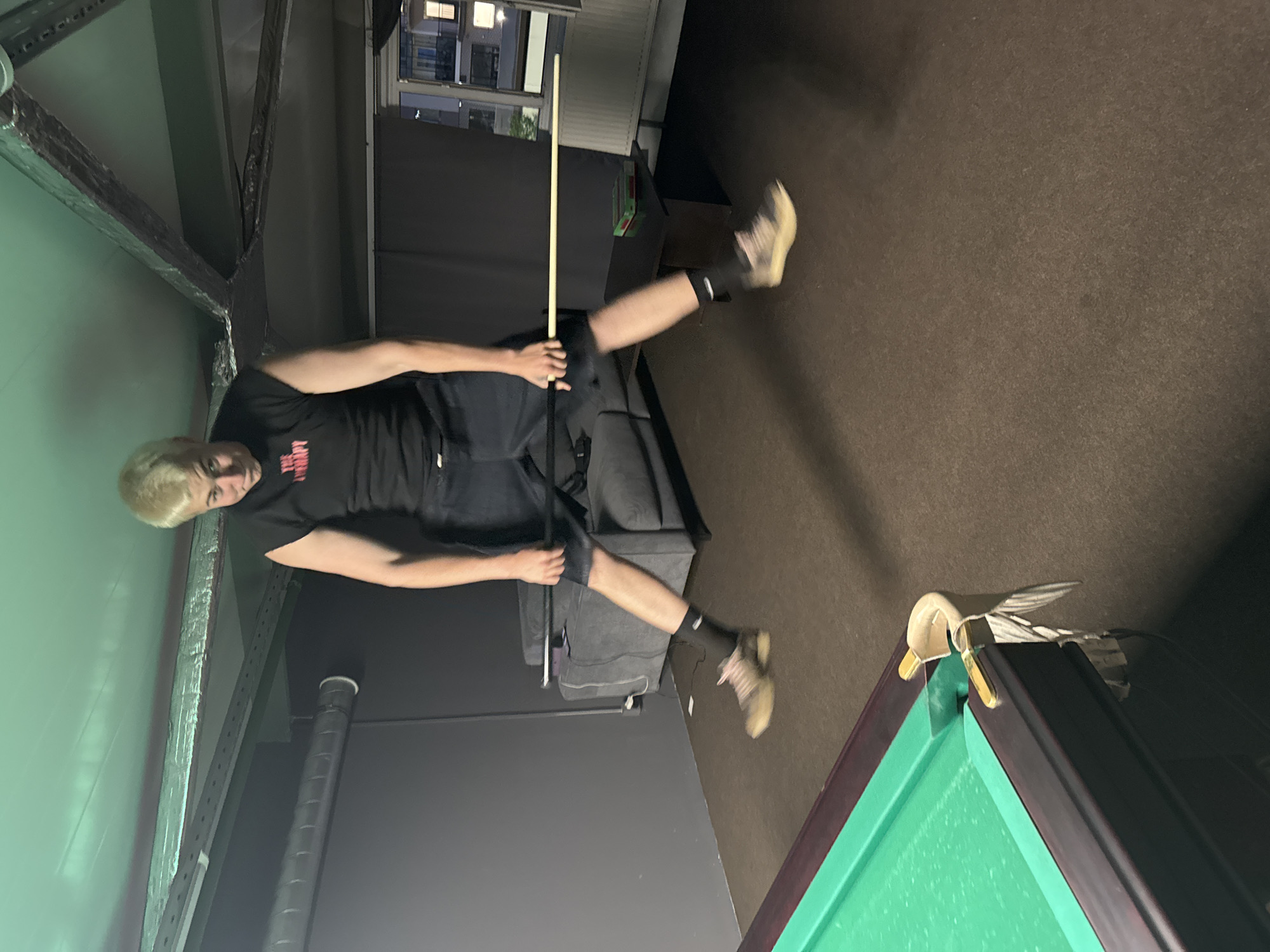 Friends enjoy casual pool game session with selfies