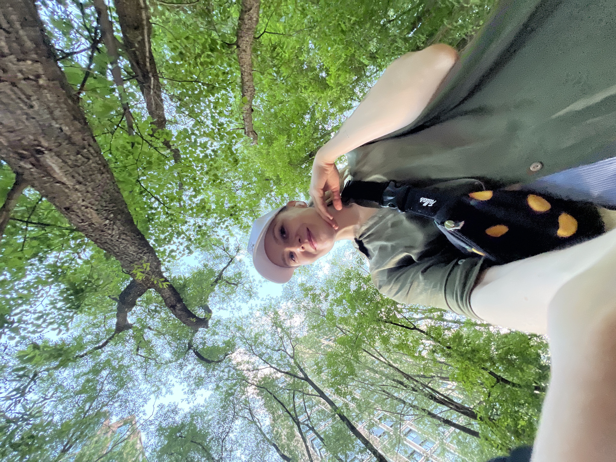 Person in white cap observed under trees in Khimki