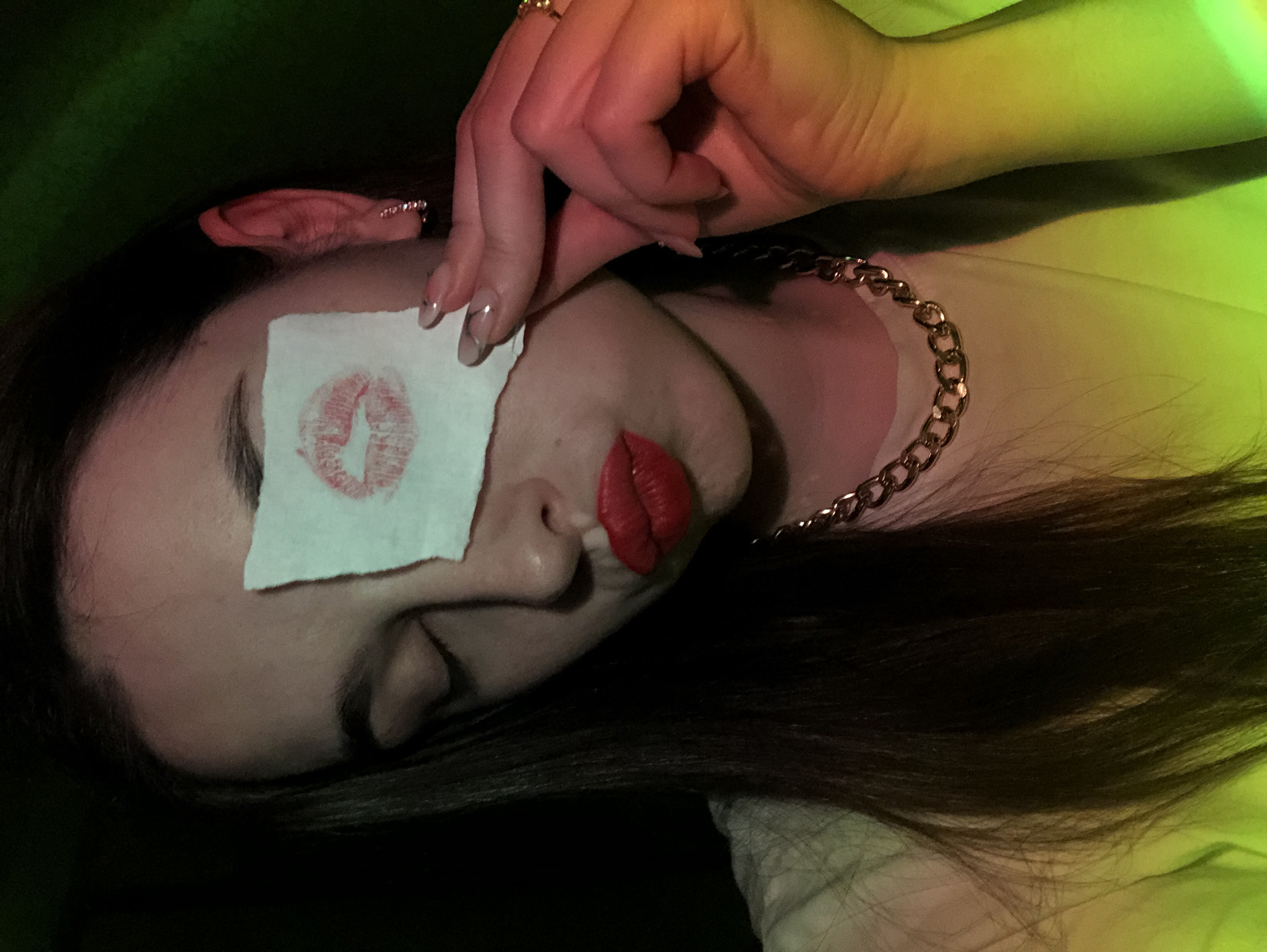 Woman photographed with lipstick kiss paper over eye in Russia
