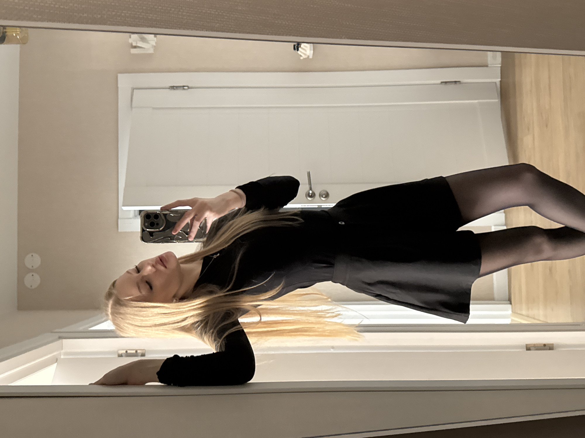 Woman takes multiple selfies indoors in Perm, Russia