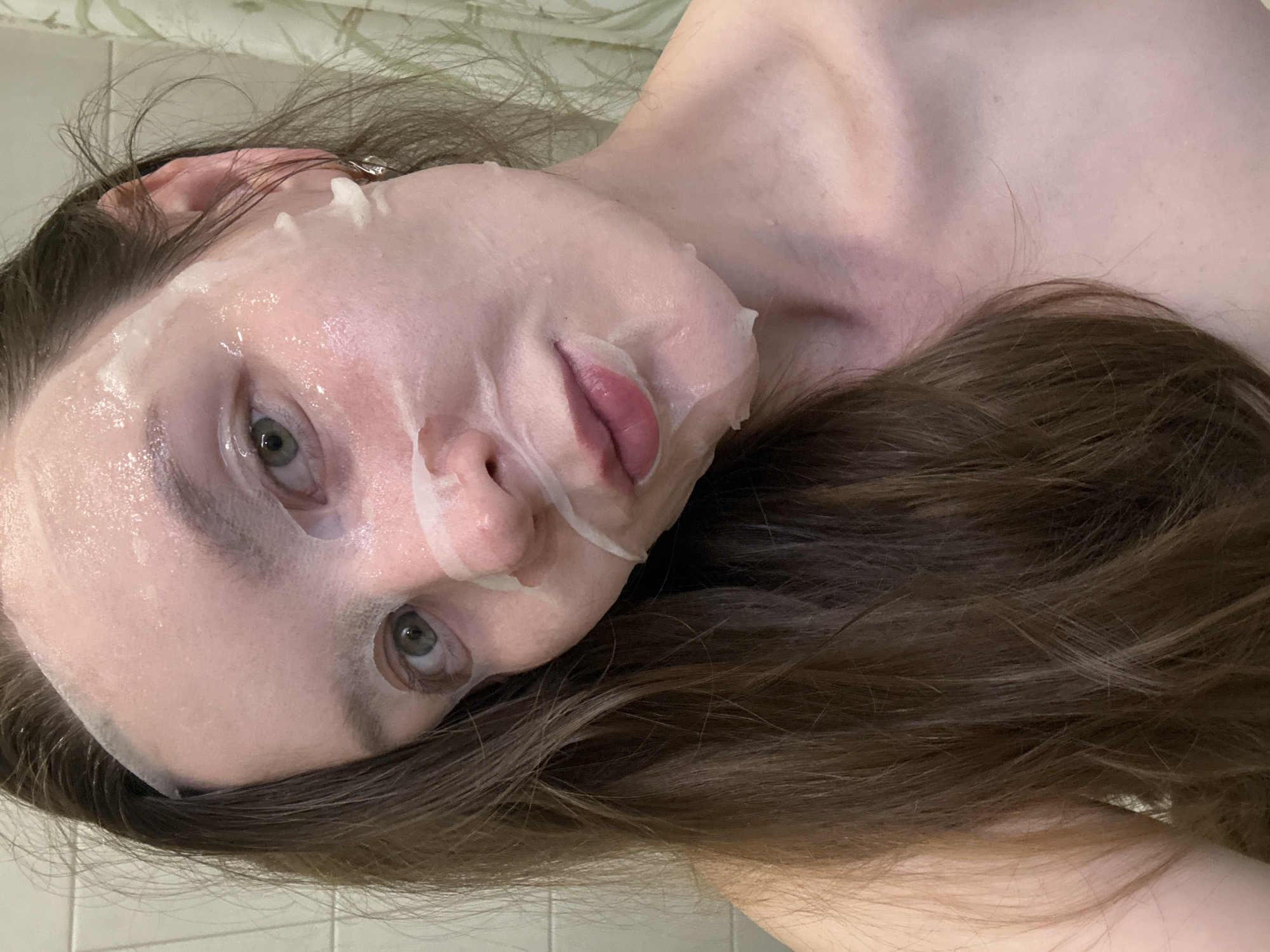 Woman documents skincare routine with facial mask in Izhevsk