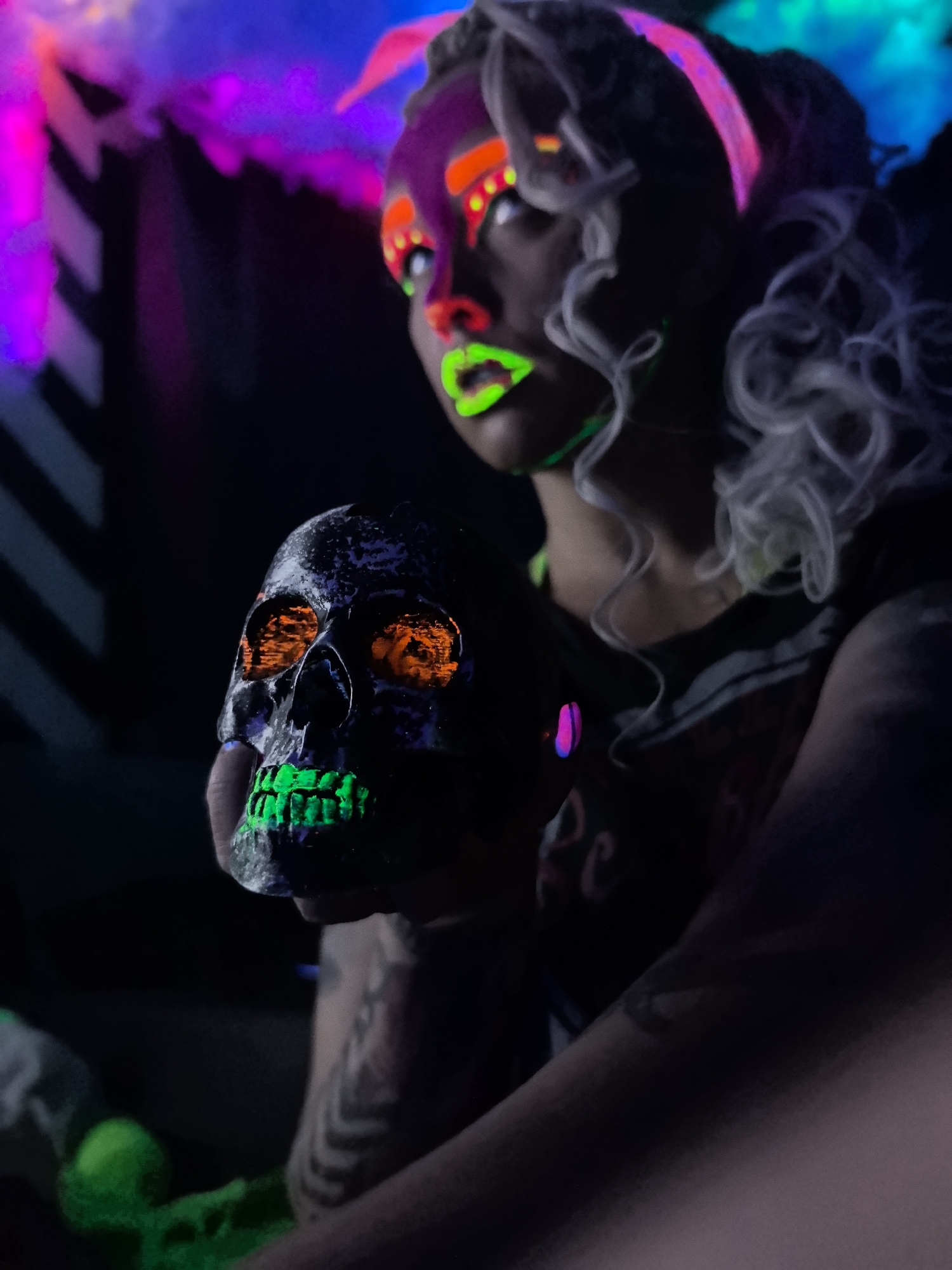 Neon makeup and glowing skulls at a UV party in Noviy