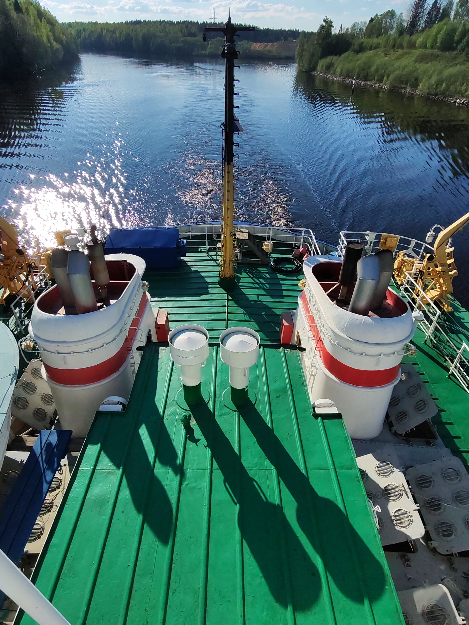 Man travels by riverboat through sunny Depo canal