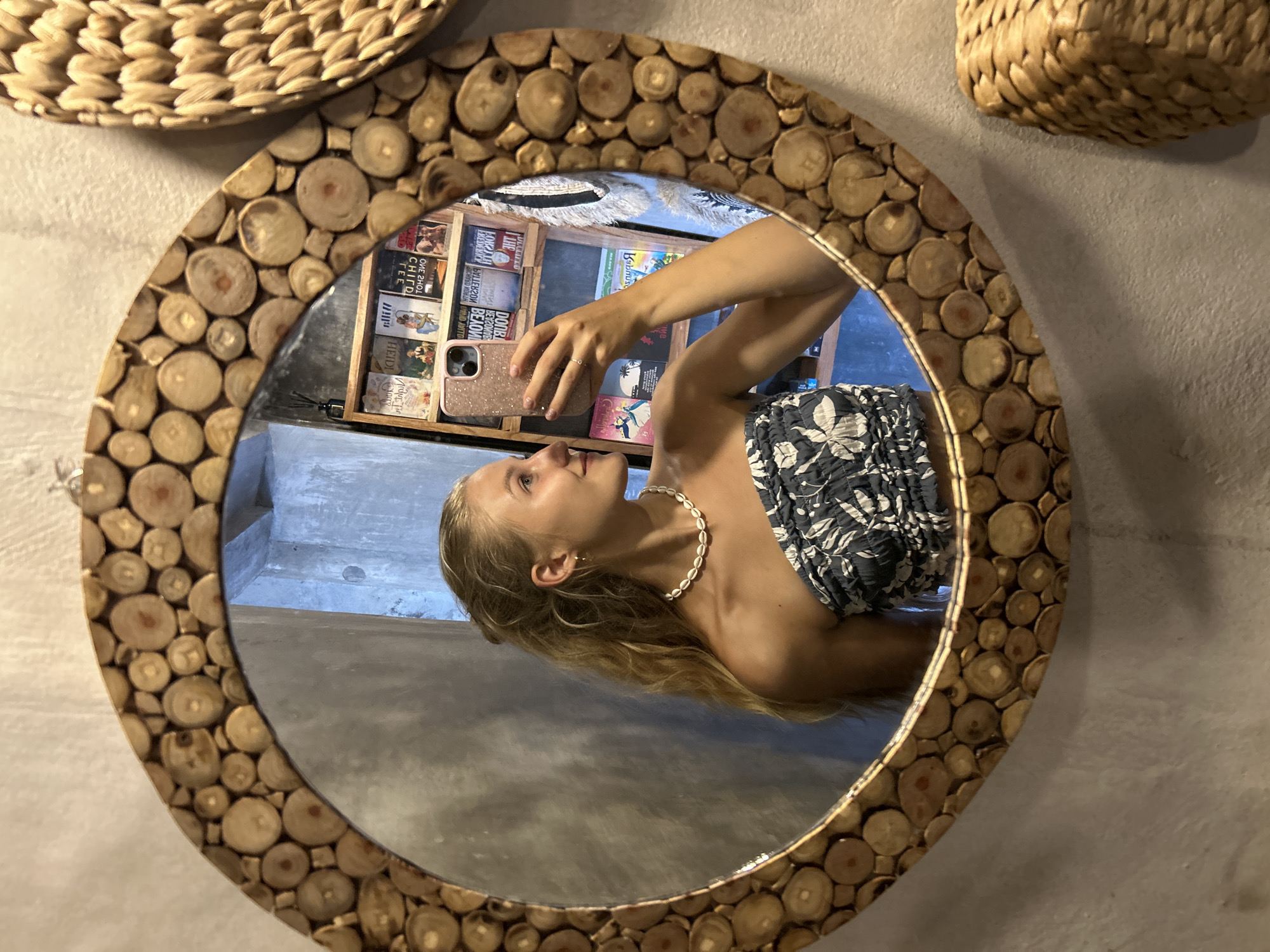 Woman takes mirror selfies at decorated Sukawati location