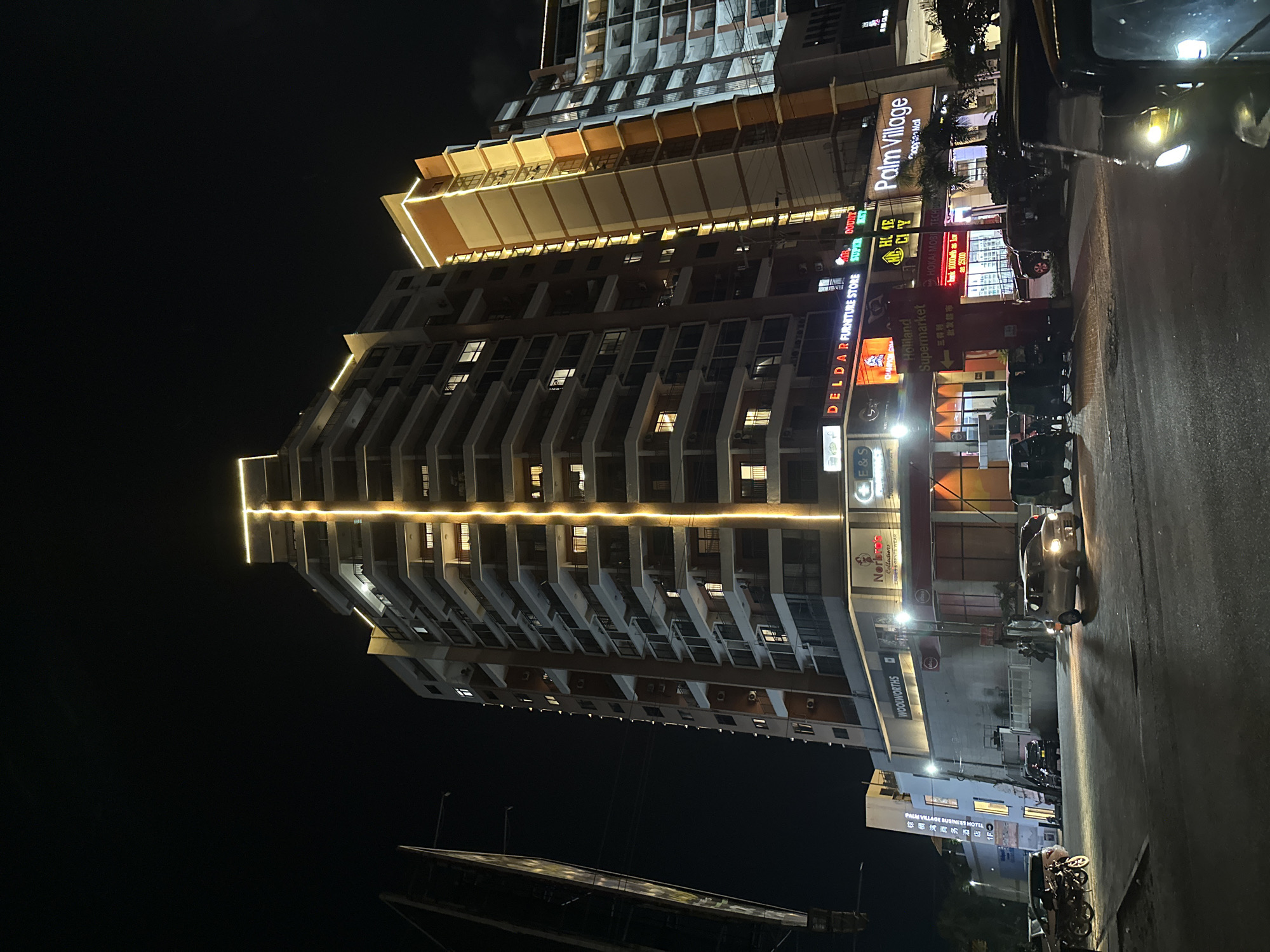 Dar es Salaam nightlife strip, neon lights and wet streets