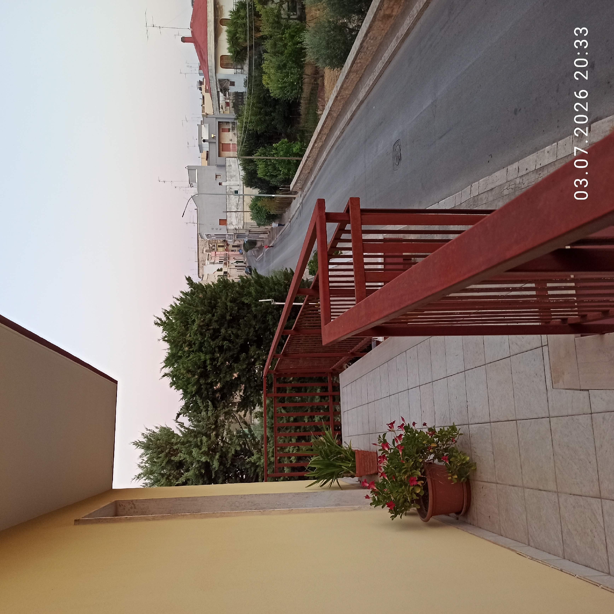 Dusk settles over a quiet residential neighborhood in Bitonto, Italy