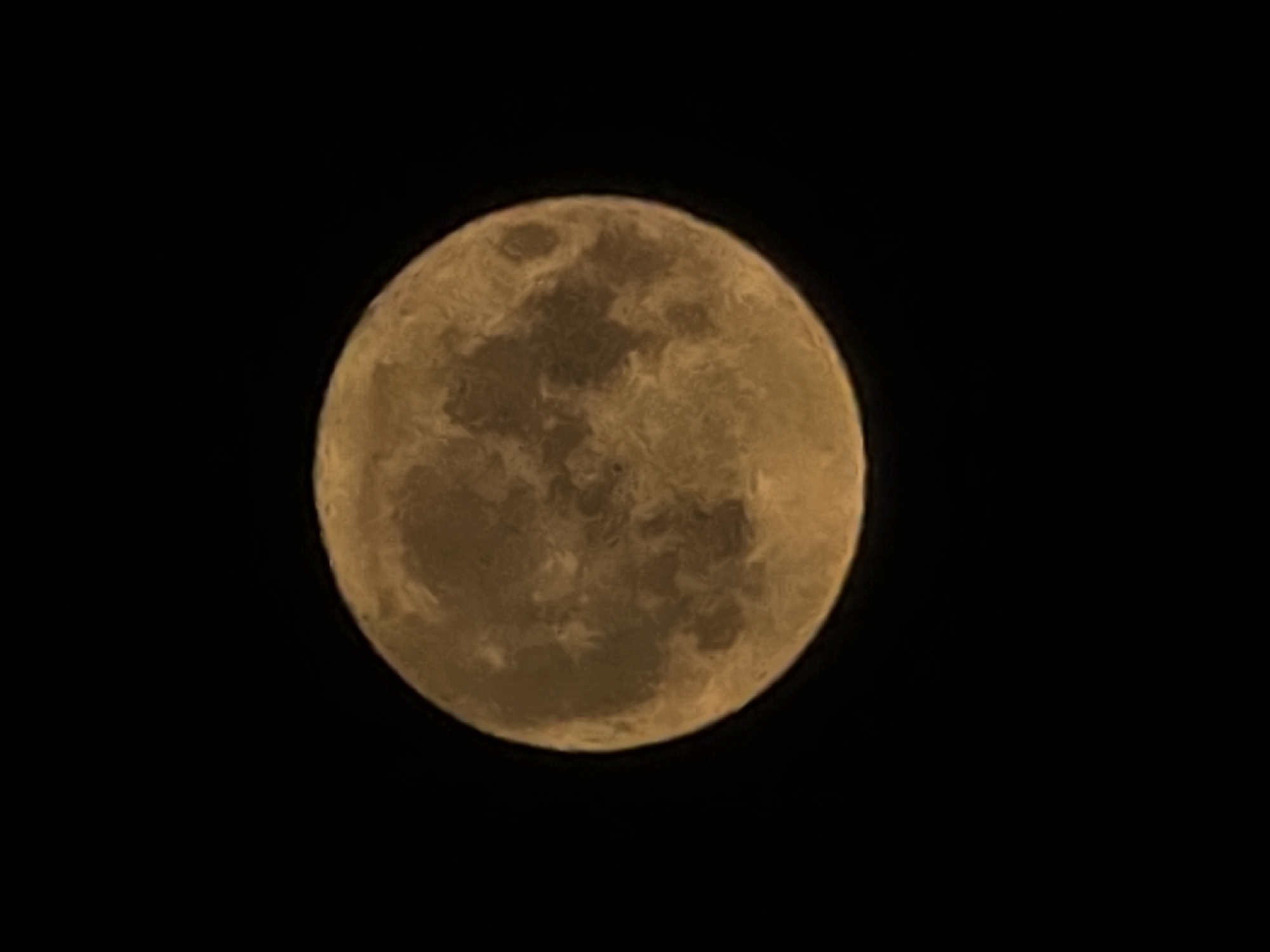 Full moon rising over Worms, warm and crater-detailed