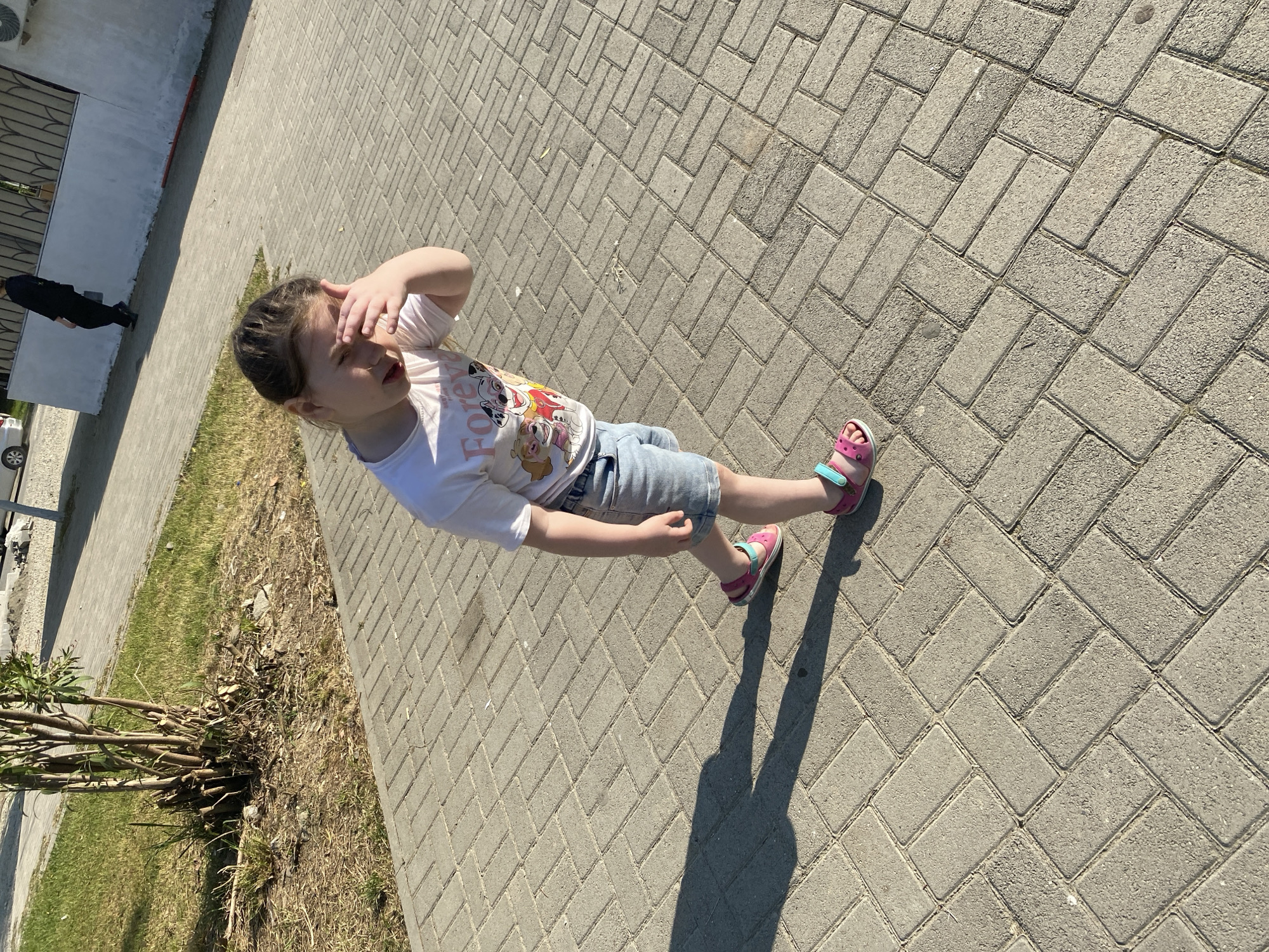 Child plays at urban park during sunny afternoon