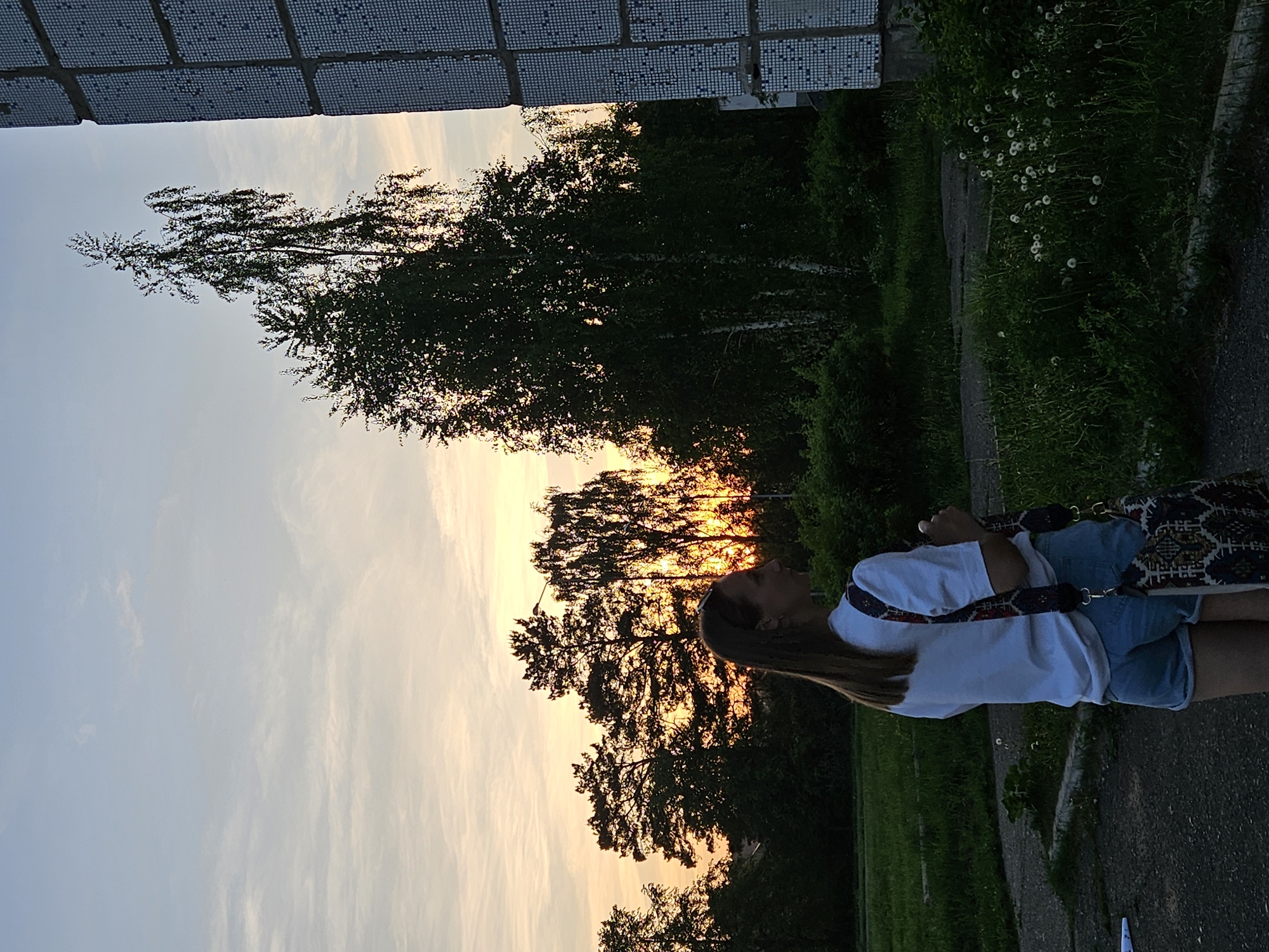 Woman enjoys spring flowers during sunset photoshoot in Chaikovsky