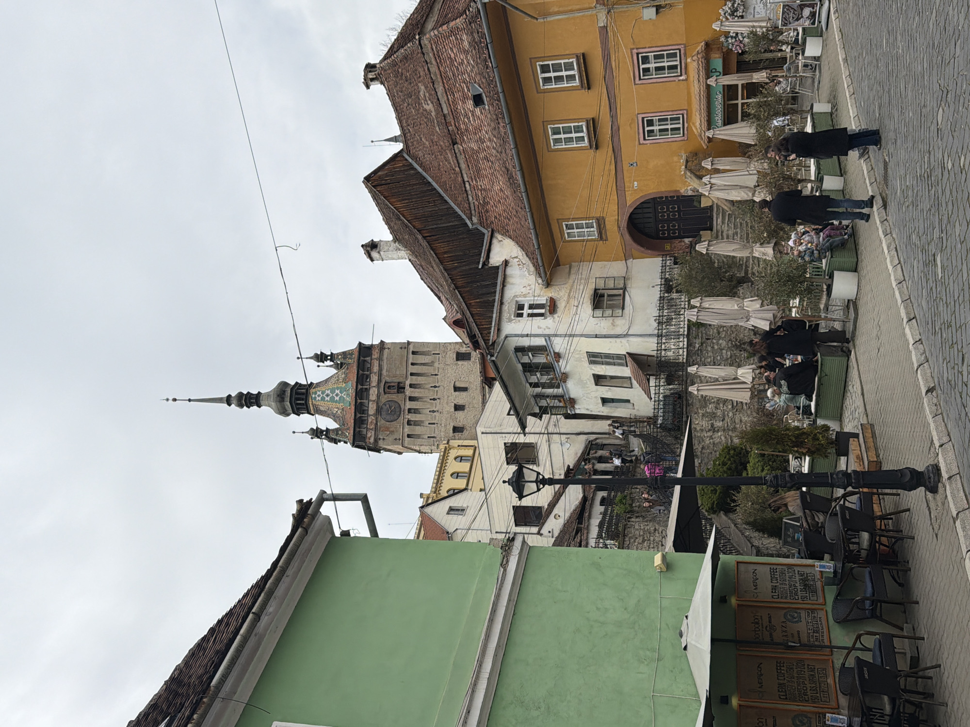 Tourist documents historic Sighișoara's medieval streets and landmarks